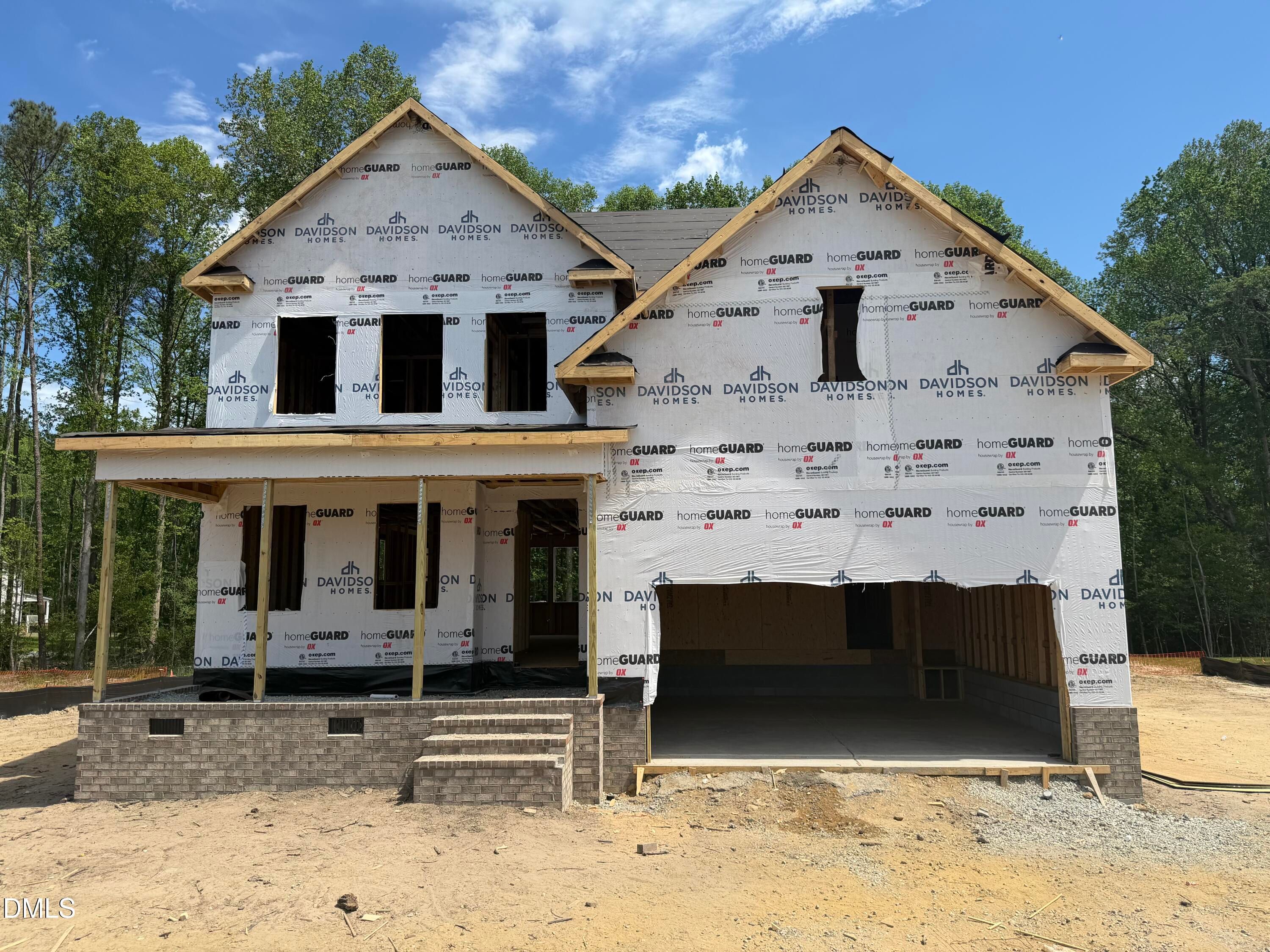 Two-story Davidson Homes Hickory II C under construction in Wellers Knoll, Lillington, NC, with front porch and open 2-car garage
