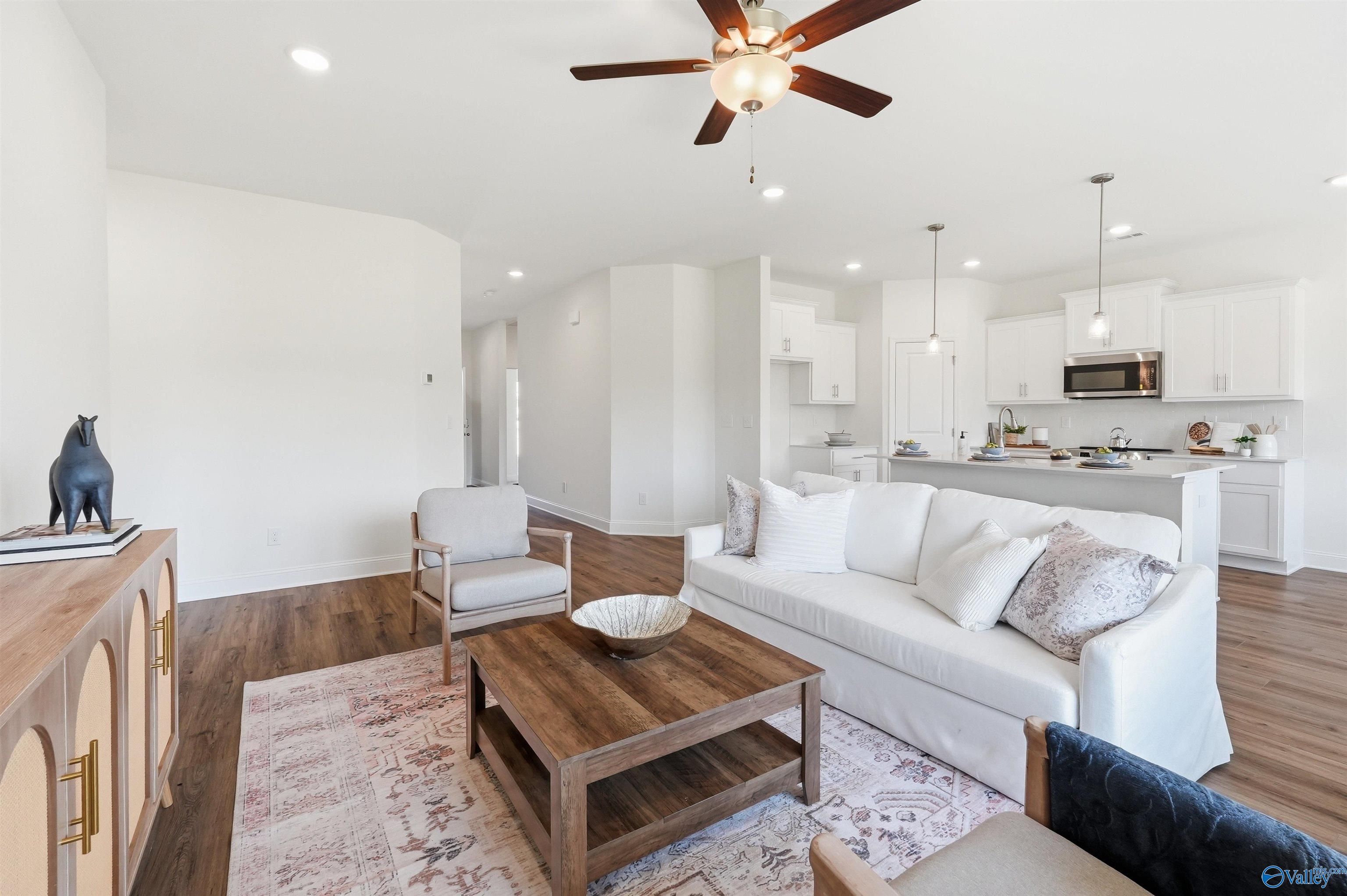 Open-concept living room and kitchen in The Franklin C floor plan by Davidson Homes in Lynn Meadows, Meridianville, Alabama.