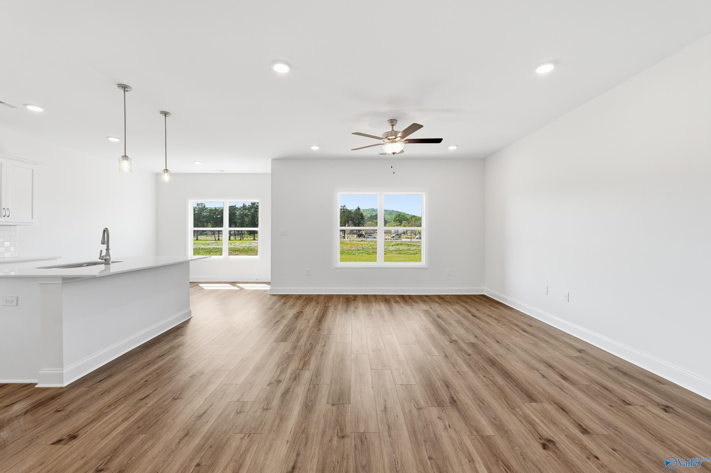 Open-concept living room with hardwood floors in The Asheville floor plan at Jaguar Hills, Huntsville, Alabama.