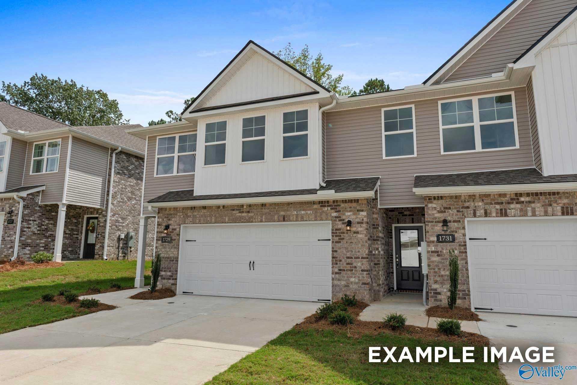 Modern two-story Camden home exterior with gray siding, brick accents, two-car garage, and landscaped driveway in Pavilion, Huntsville, Alabama