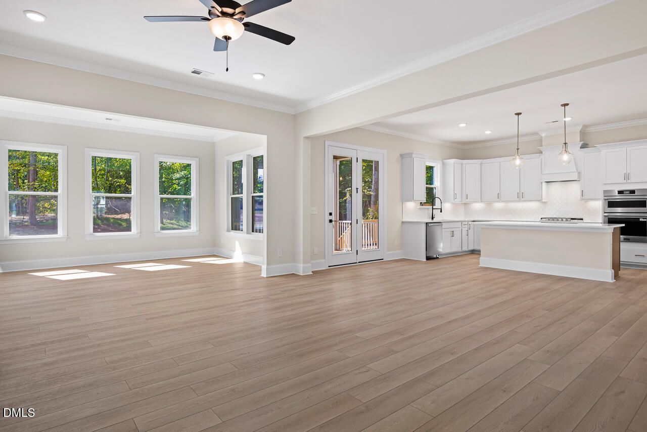 Open-concept living room and white kitchen with island in Davidson Homes The Crawford D plan, Wake Forest, North Carolina