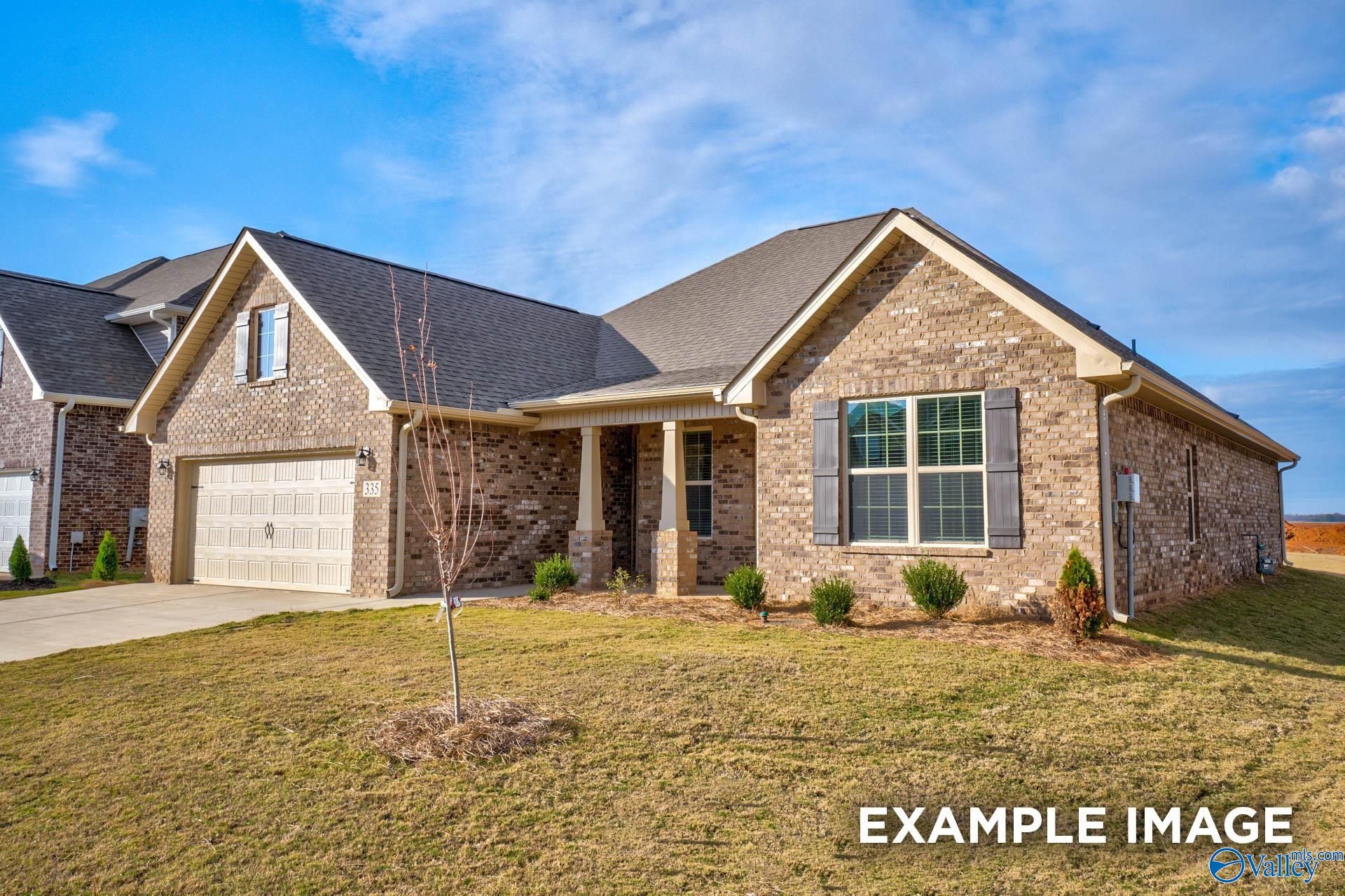 Single-story brick home with 2-car garage, covered porch, and landscaped front yard in Pikes Ridge, Meridianville, Alabama Davidson Homes Rockford