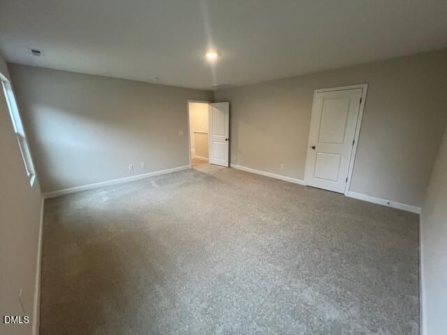 Spacious carpeted bedroom with natural light and walk-in closet access in Davidson Homes The Willow D, Wellers Knoll, Lillington NC