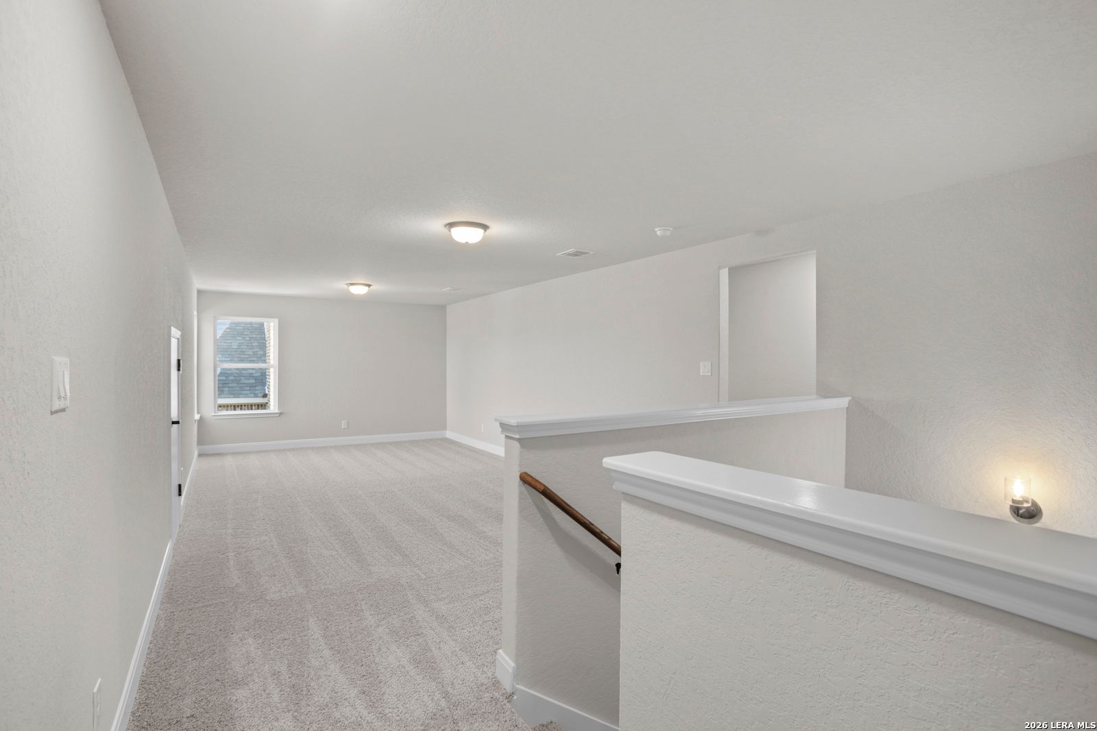 Spacious carpeted loft area in The Jennings G floor plan by Davidson Homes in Ladera, San Antonio, Texas.