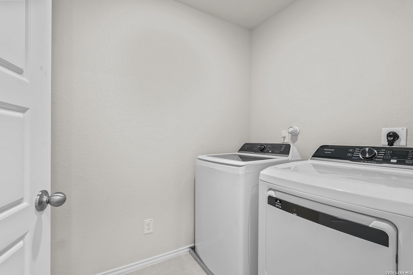 Dedicated laundry room with washer and dryer in The Gillian B floor plan at Meadows at Oak Creek, San Antonio, Texas.