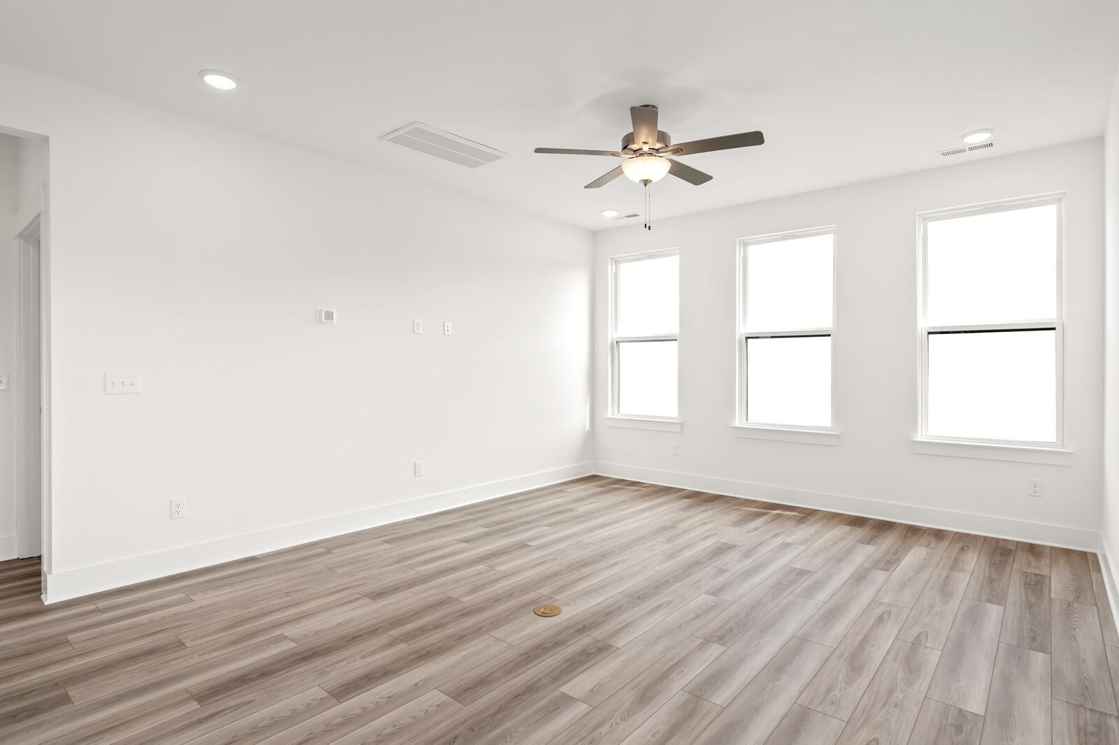 Bright living room with hardwood floors, large windows, ceiling fan in Davidson Homes The Ash C, Mt. Juliet, TN