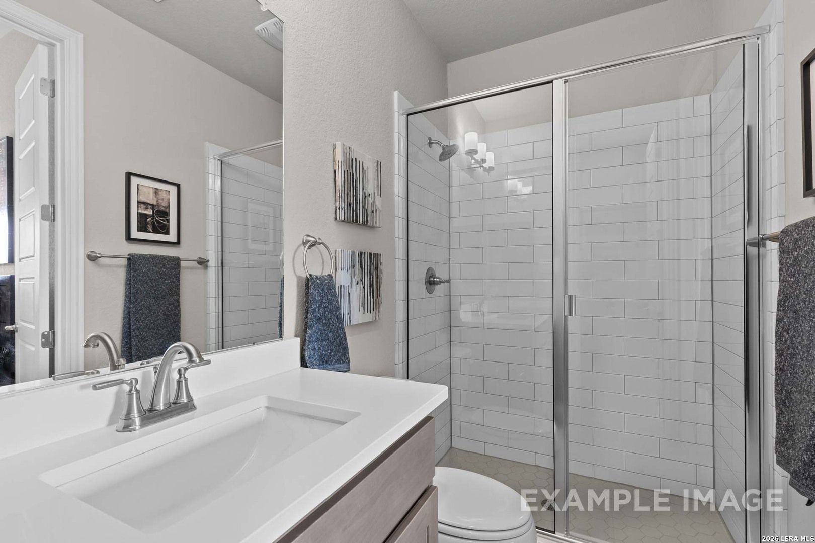 Modern bathroom with white subway tile shower and vanity in The Garner C floor plan at The Reserve at Potranco Oaks.
