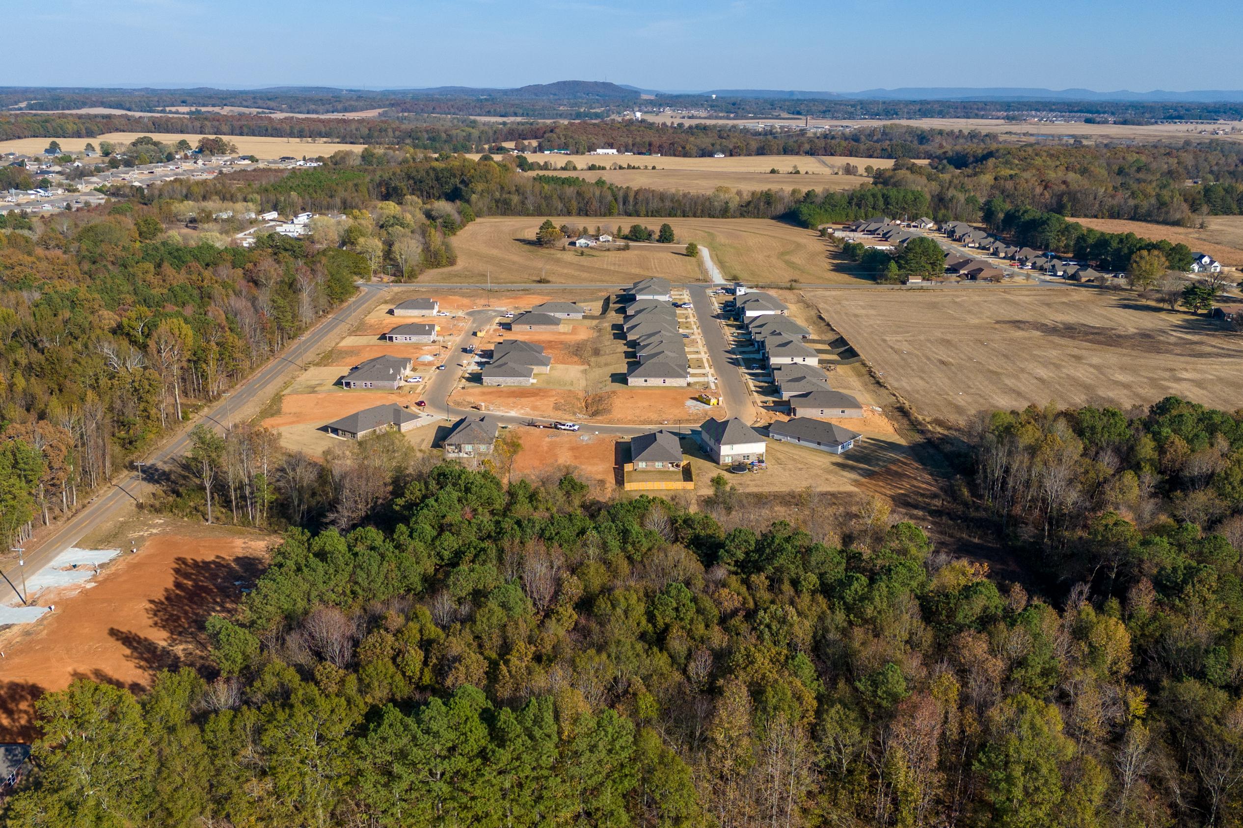 Aerial view of new homes at Mallard Landing in Athens Alabama surrounded by autumn woods and farmland