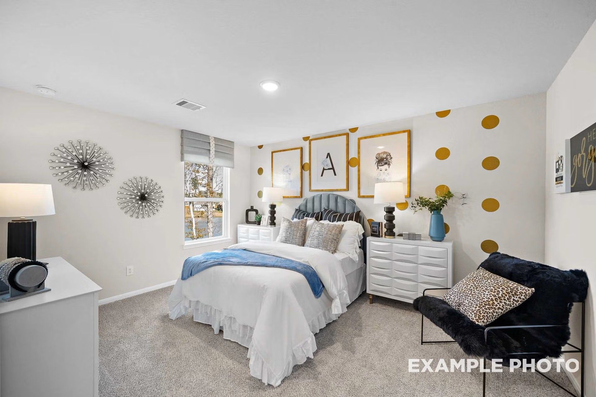 Stylish bedroom with gold polka dot accent wall in The San Marcos E floor plan by Davidson Homes in Heartland, Texas.
