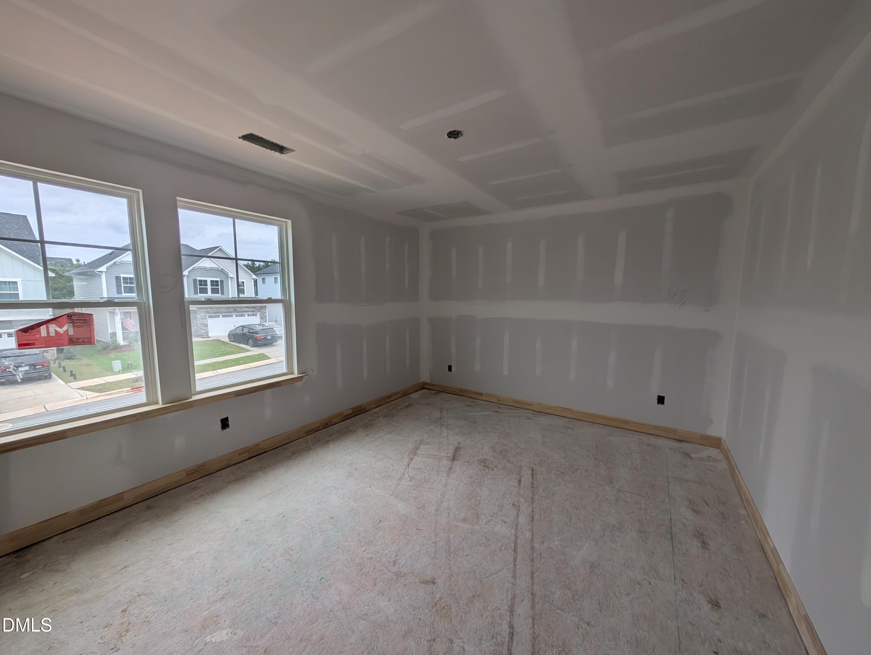 Unfinished bedroom with double windows and coffered ceiling in Davidson Homes The Beech plan at Wendell Ridge, Wendell, NC