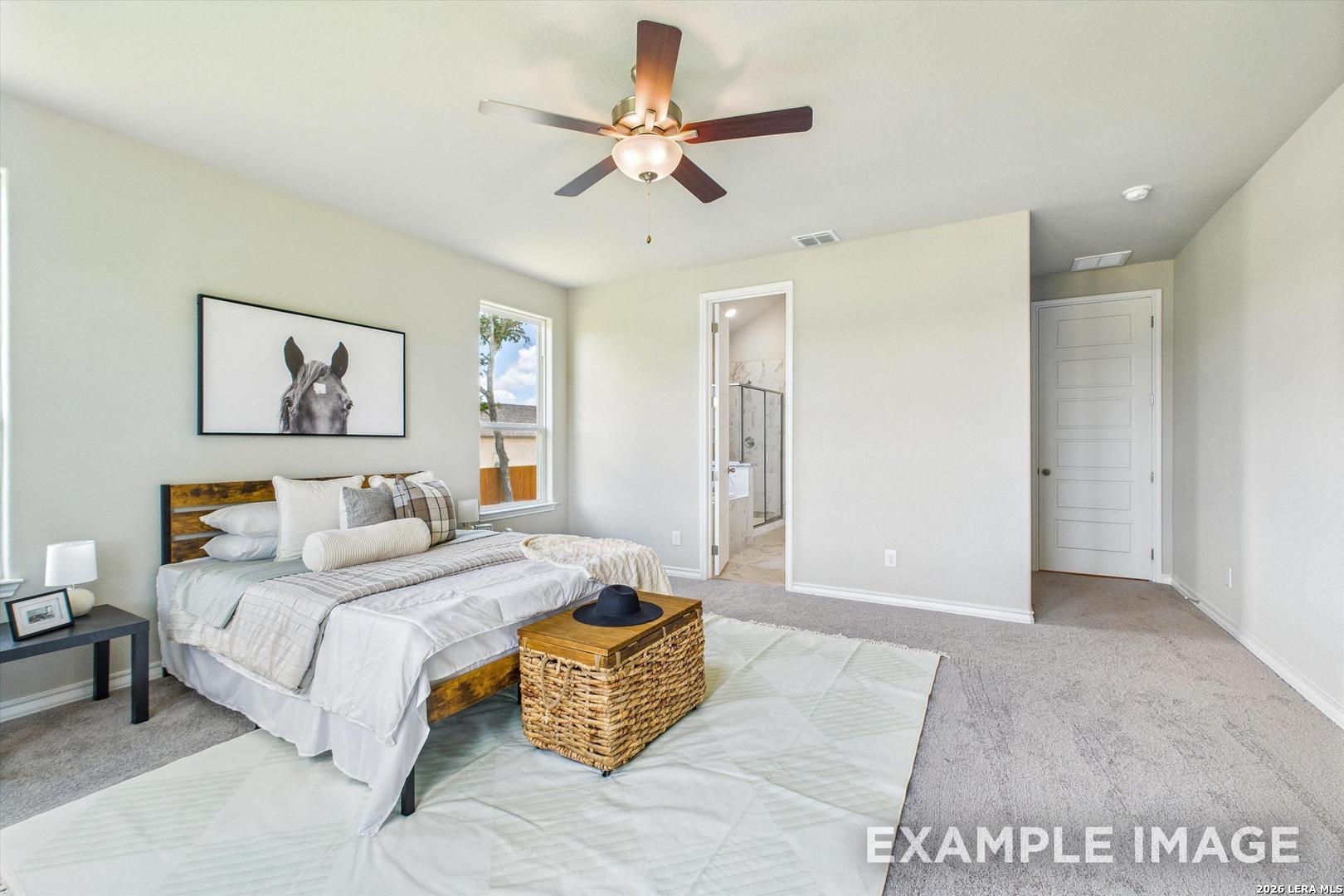 Spacious bedroom with en-suite bathroom in The Foster F floor plan by Davidson Homes, Potranco Oaks, Castroville, Texas.
