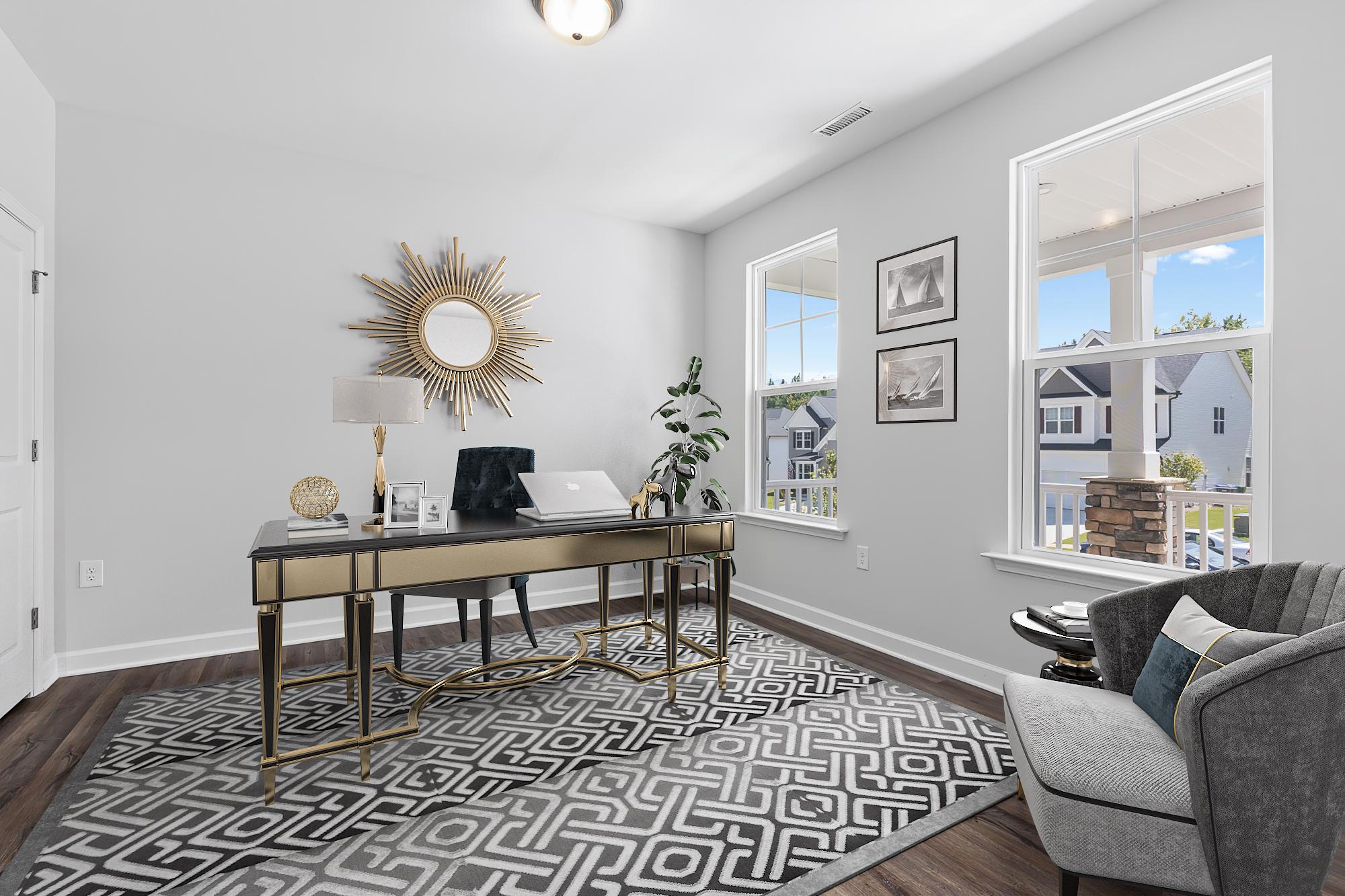 Modern home office at Enclave at Belmont in Belmont NC with sleek black desk gold sunburst mirror and neighborhood views