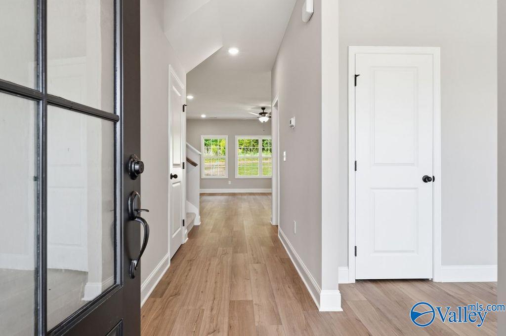 Bright foyer entrance with wood-look flooring in The Rockford floor plan by Davidson Homes in Cain Park, Hartselle, AL.