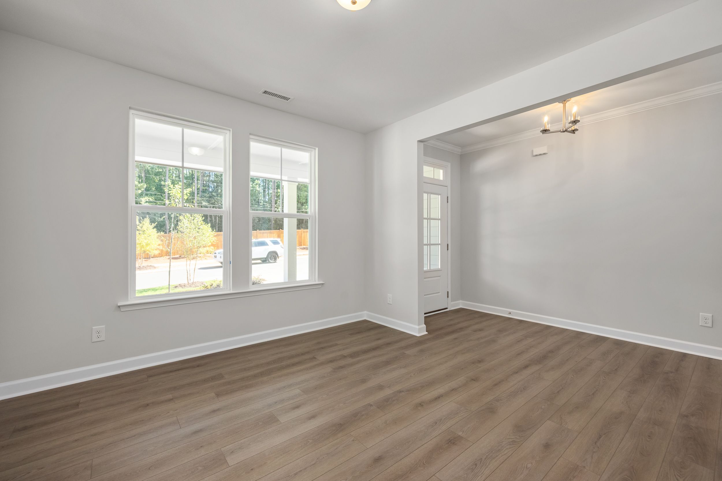 Spacious entryway in The Aspen C home with large windows, hardwood floors, and arched doorway