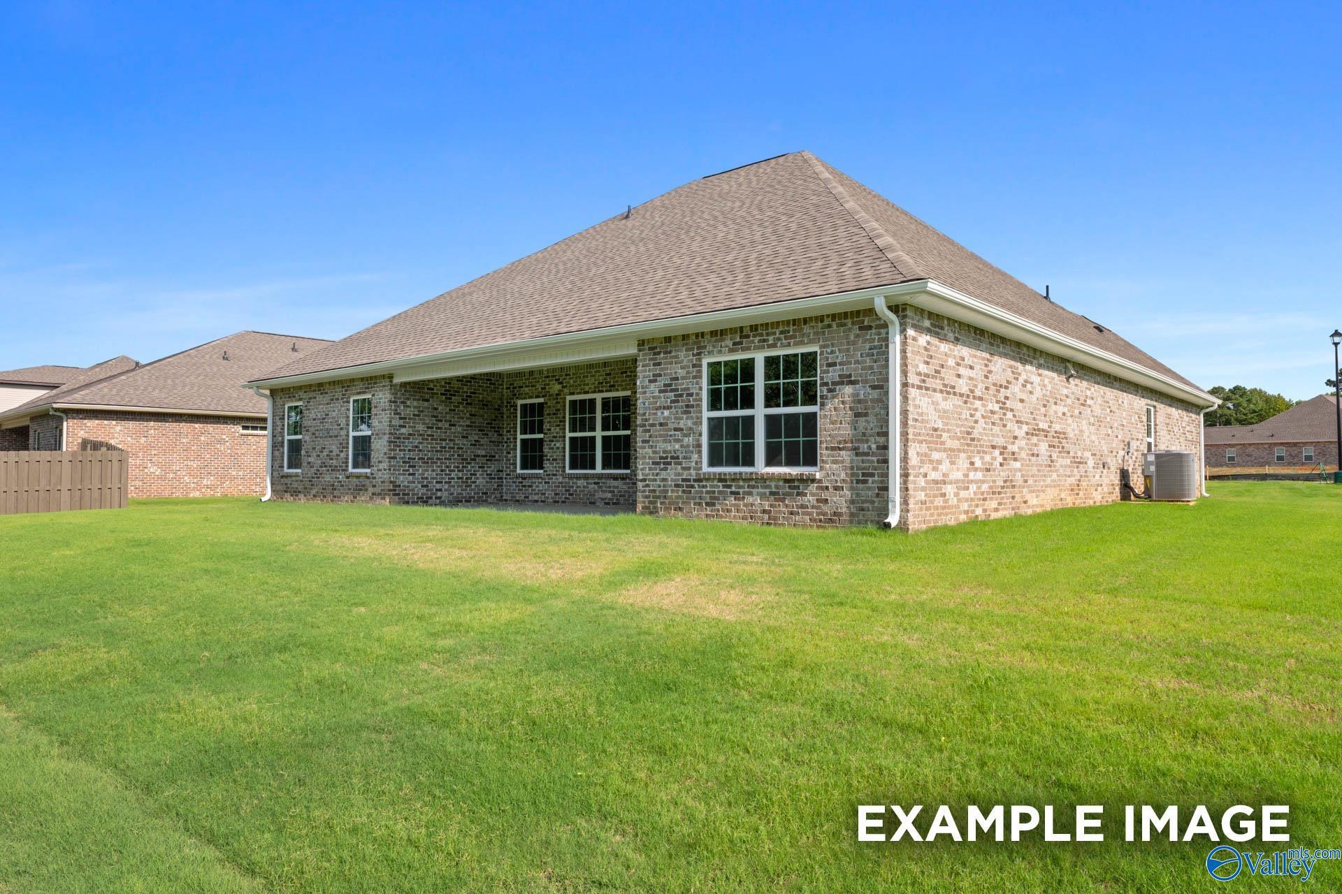 Brick 1.5-story Davidson Homes The Rockford with Bonus exterior: shingled roof, large windows, 2-car garage, lush green lawn in Barnett's Crossing, Madison, Alabama