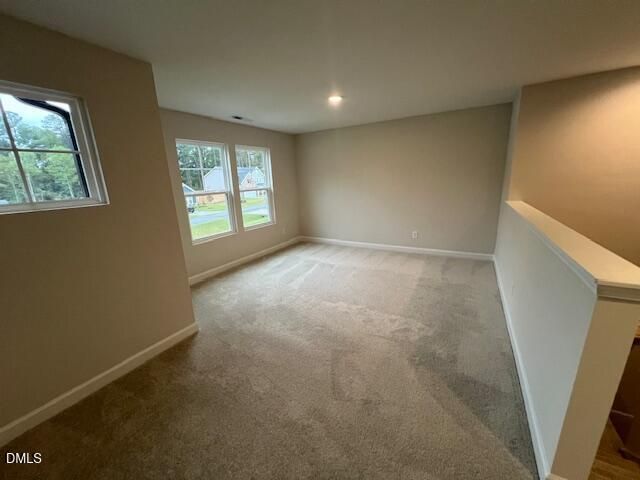 Spacious carpeted upstairs bonus room with natural light in Davidson Homes The Willow D floor plan, Wellers Knoll, Lillington, NC