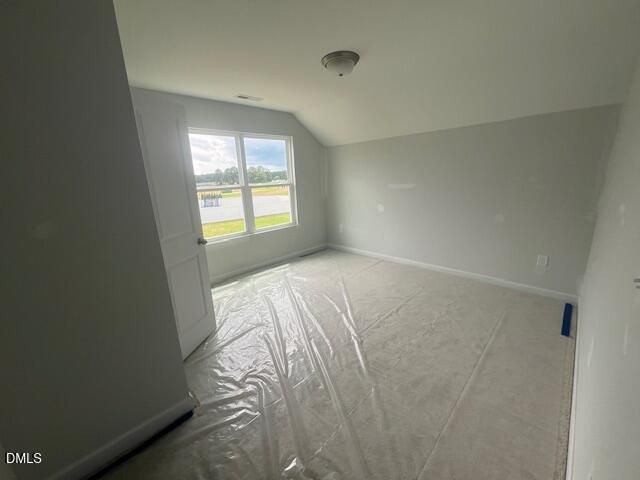 Bright, unfinished bedroom with carpet protection in The Ash B floor plan at Retreat at North Main, Lillington, NC.
