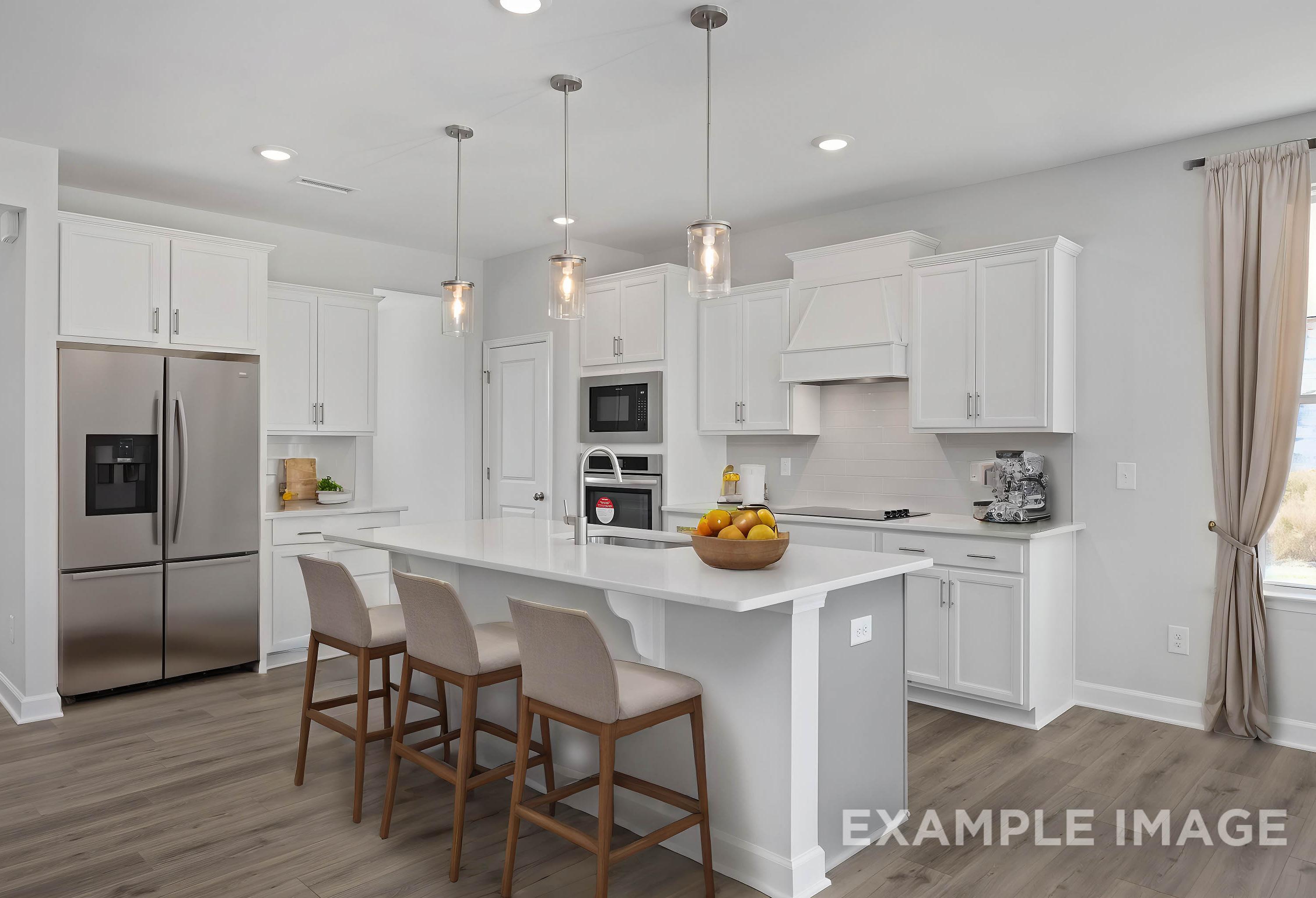 Modern white kitchen in The Ash home with large center island, stainless steel fridge, pendant lights, and bar stools