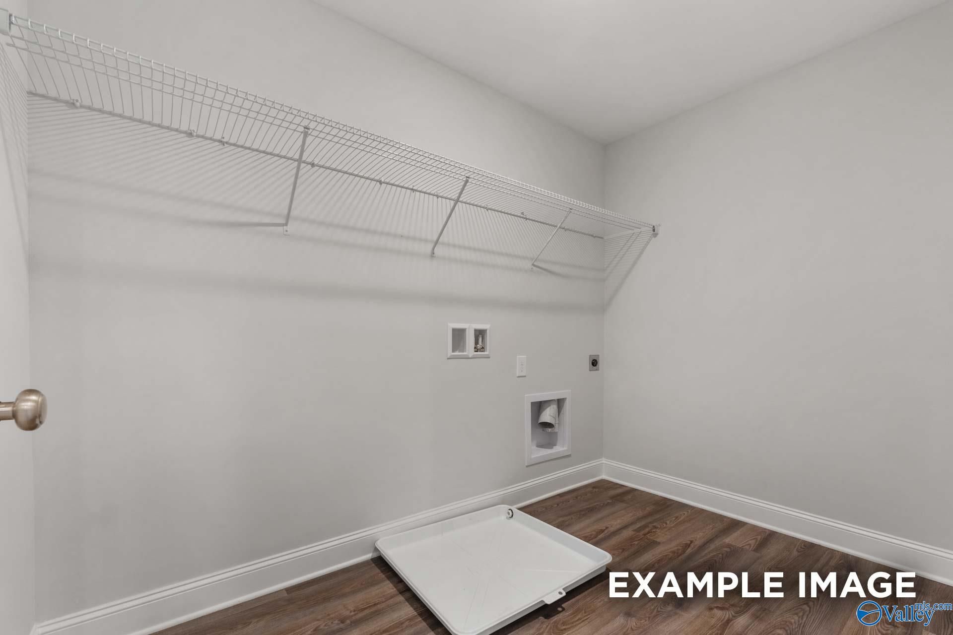 Modern laundry room with wire shelving, washer-dryer hookups, and drain pan in Davidson Homes Shelby C, Arab, Alabama