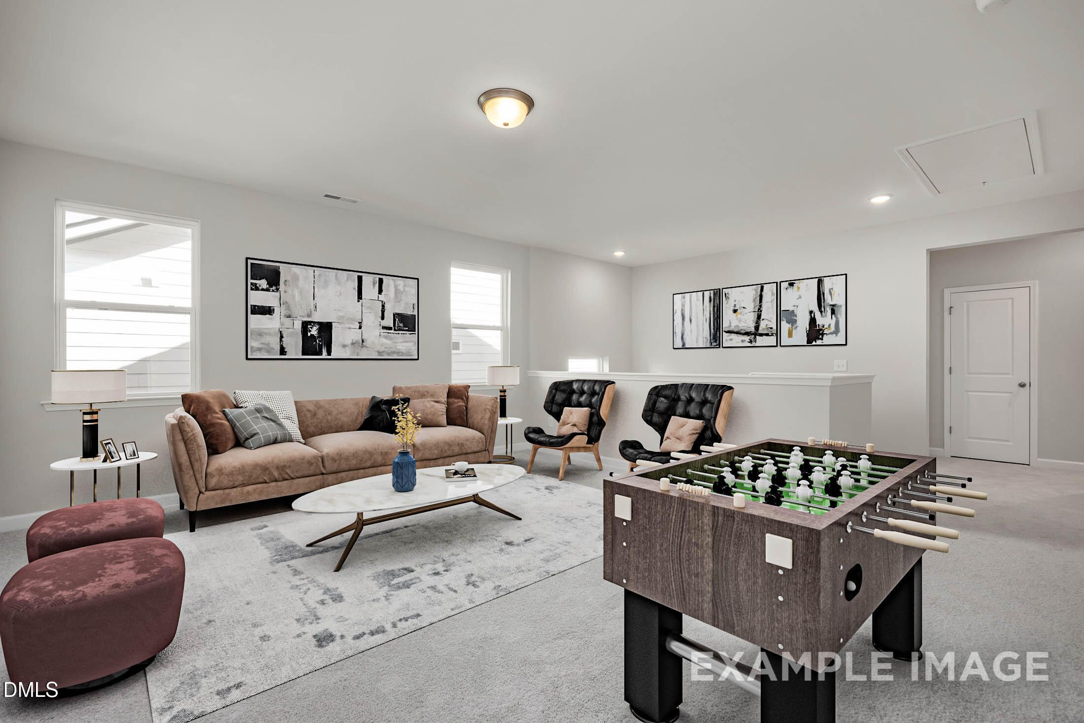 Spacious bonus room with foosball table, beige sofa, leather armchairs in Davidson Homes The Aspen C, Apex, NC