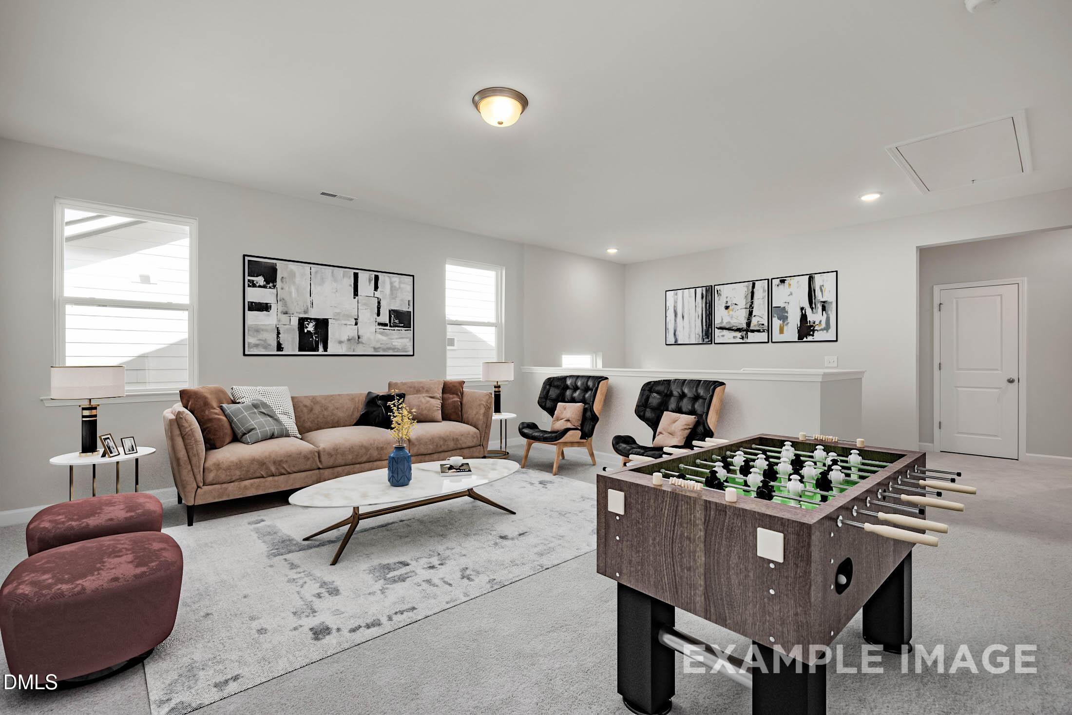Spacious loft with foosball table and seating in The Aspen C floor plan by Davidson Homes in Ashland, Apex, North Carolina.