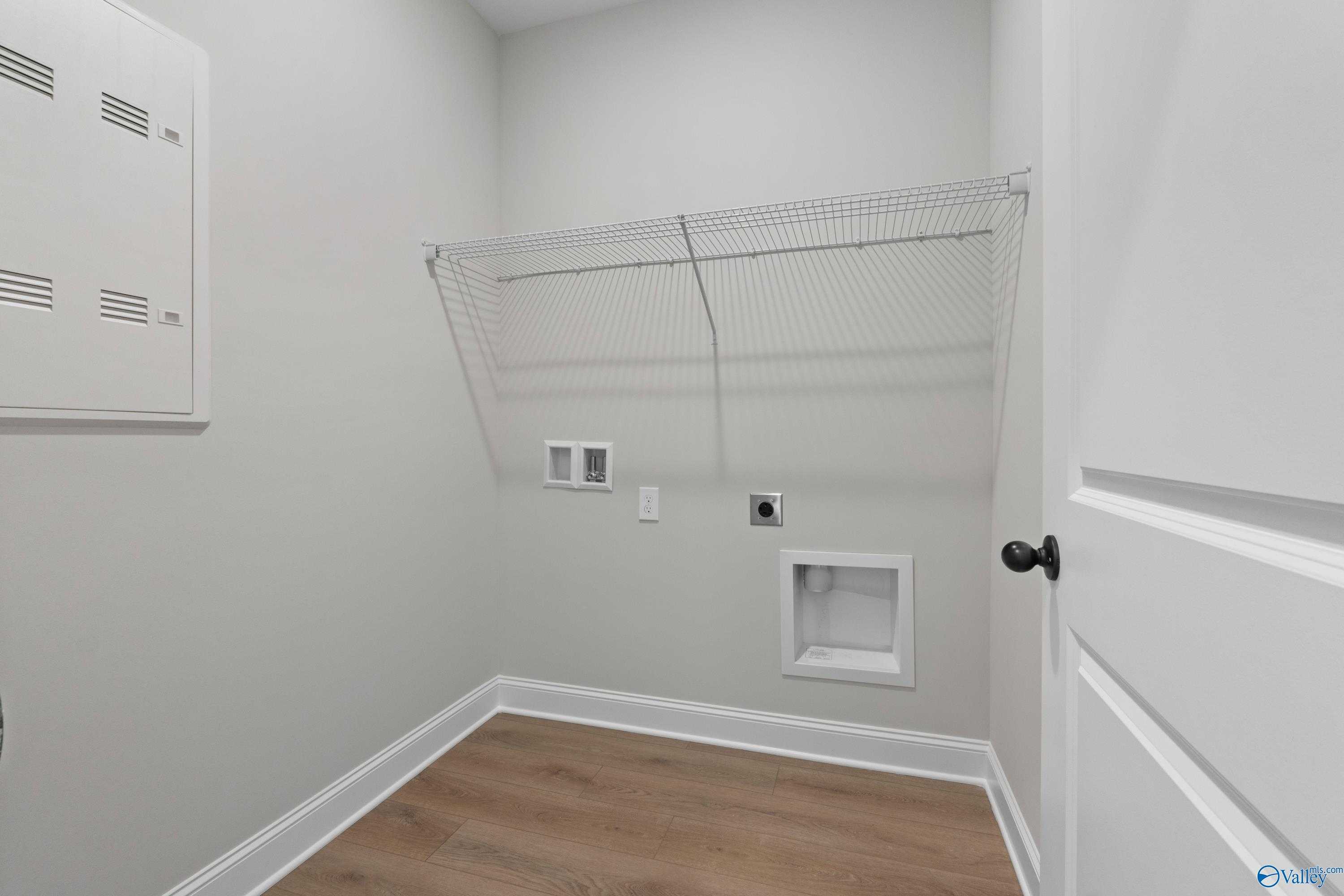 Functional laundry room with wire shelving, washer/dryer hookups in Davidson Homes The Franklin C, Hazel Green, Alabama