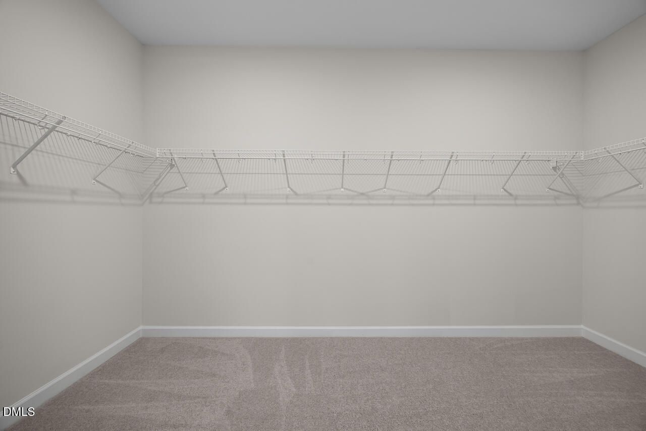 Walk-in closet with wire shelving in The Hickory II B floor plan by Davidson Homes in Montrose, Aberdeen, North Carolina.