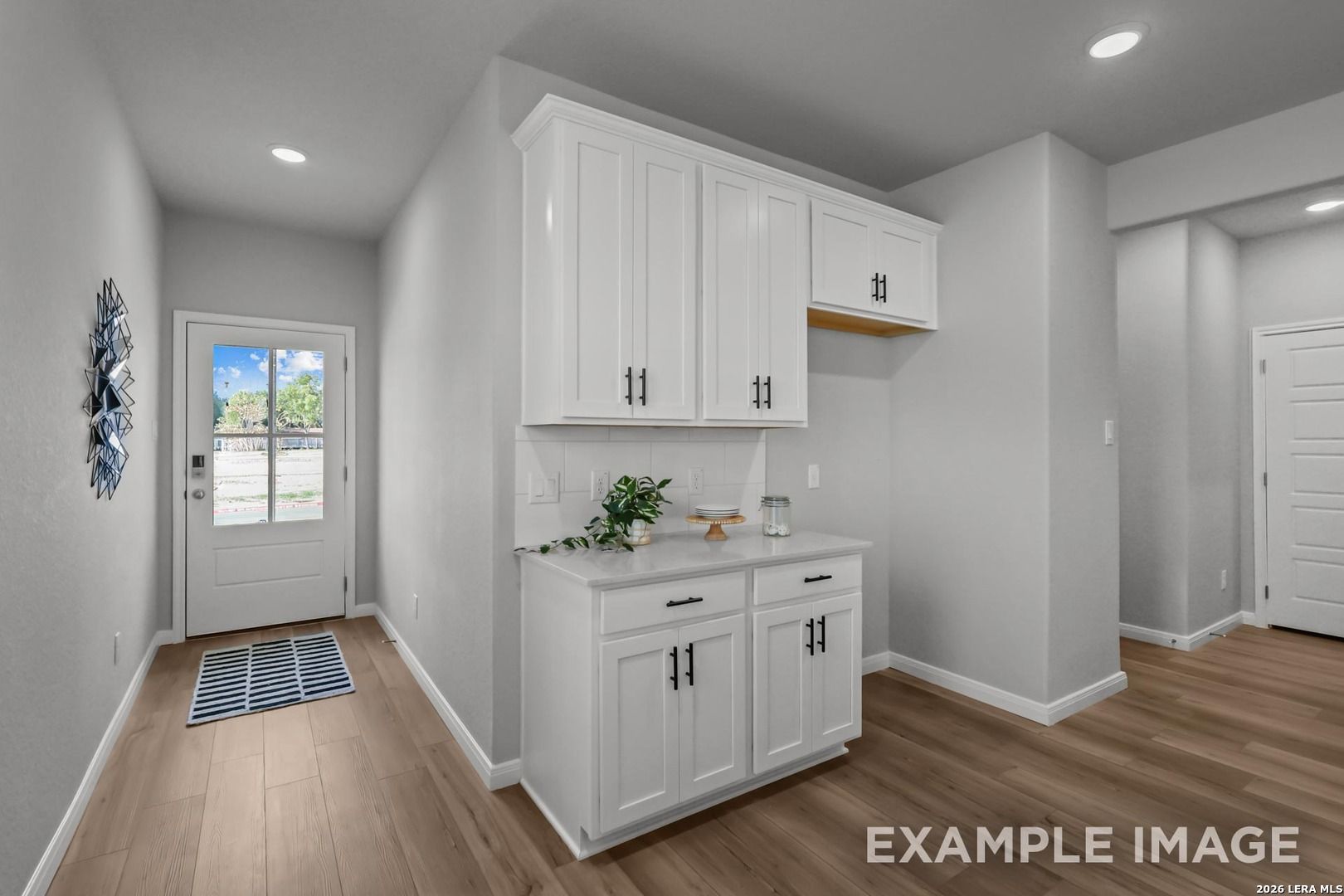 Modern butler’s pantry with white cabinetry and quartz counters in The Gillian A floor plan by Davidson Homes, San Antonio.