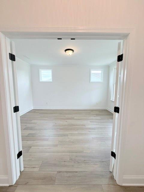 Bright home office or flex room with light wood-look flooring in The Hickory B floor plan at Wehunt Meadows, Hoschton.
