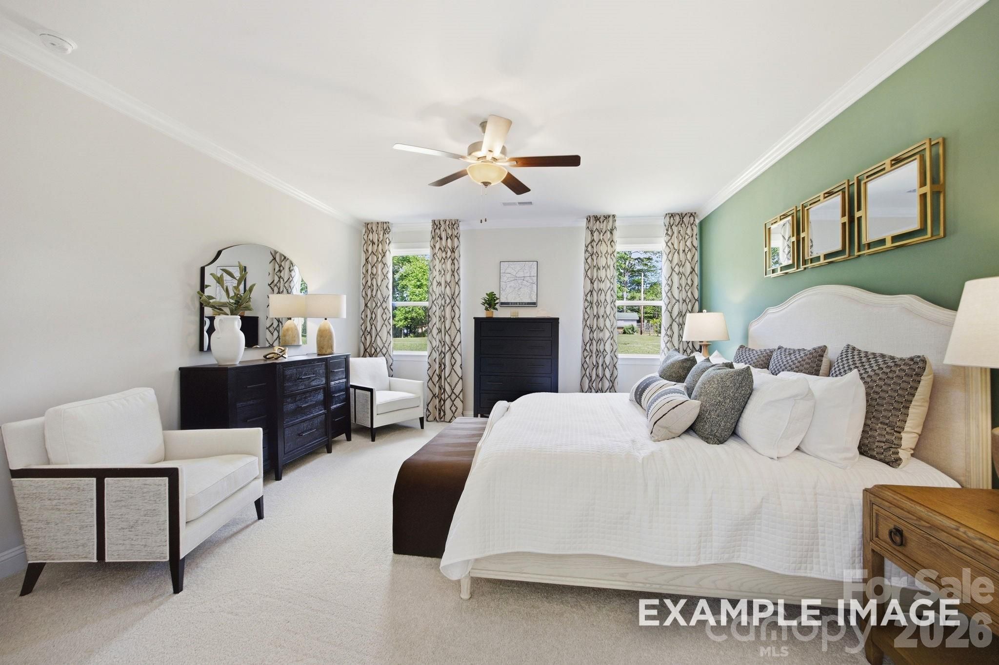 Spacious primary bedroom with green accent wall in The Hickory B II floor plan by Davidson Homes in Mooresville, NC.