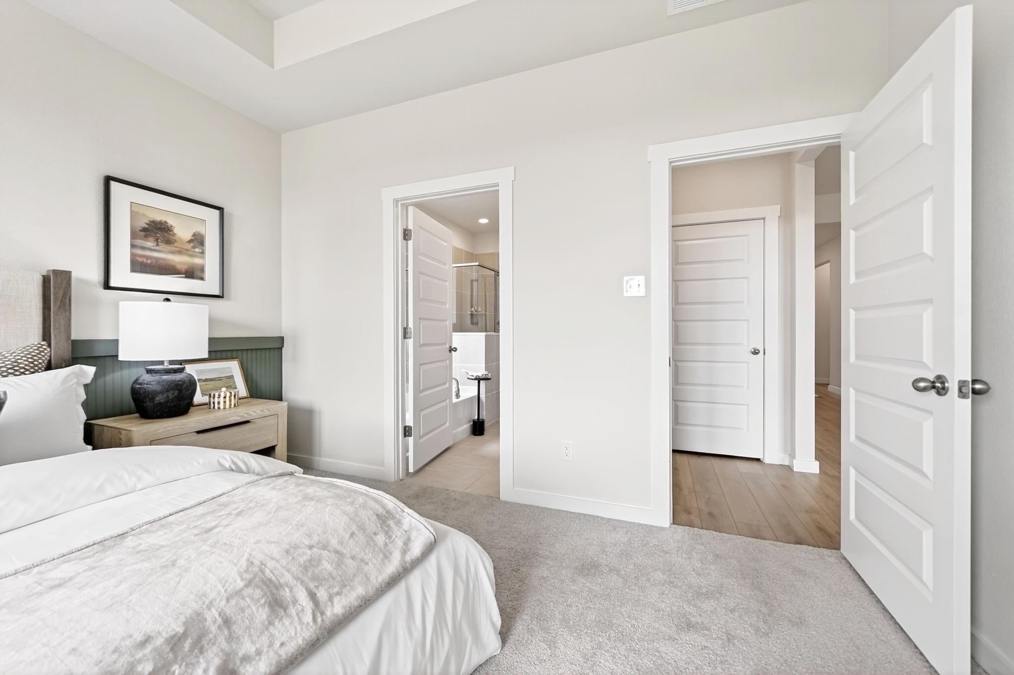 Primary bedroom with en-suite bathroom in The Laurel I floor plan by Davidson Homes in Heartland, Texas.