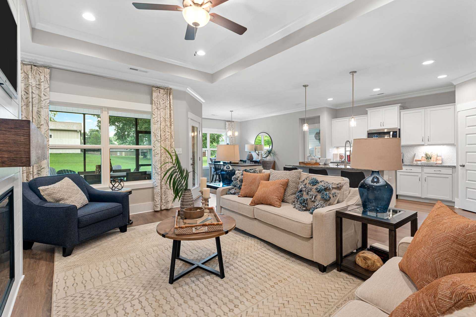 Spacious open-concept living room and kitchen at Monteagle Cove in Owens Cross Roads Alabama with neutral tones cozy seating and large windows