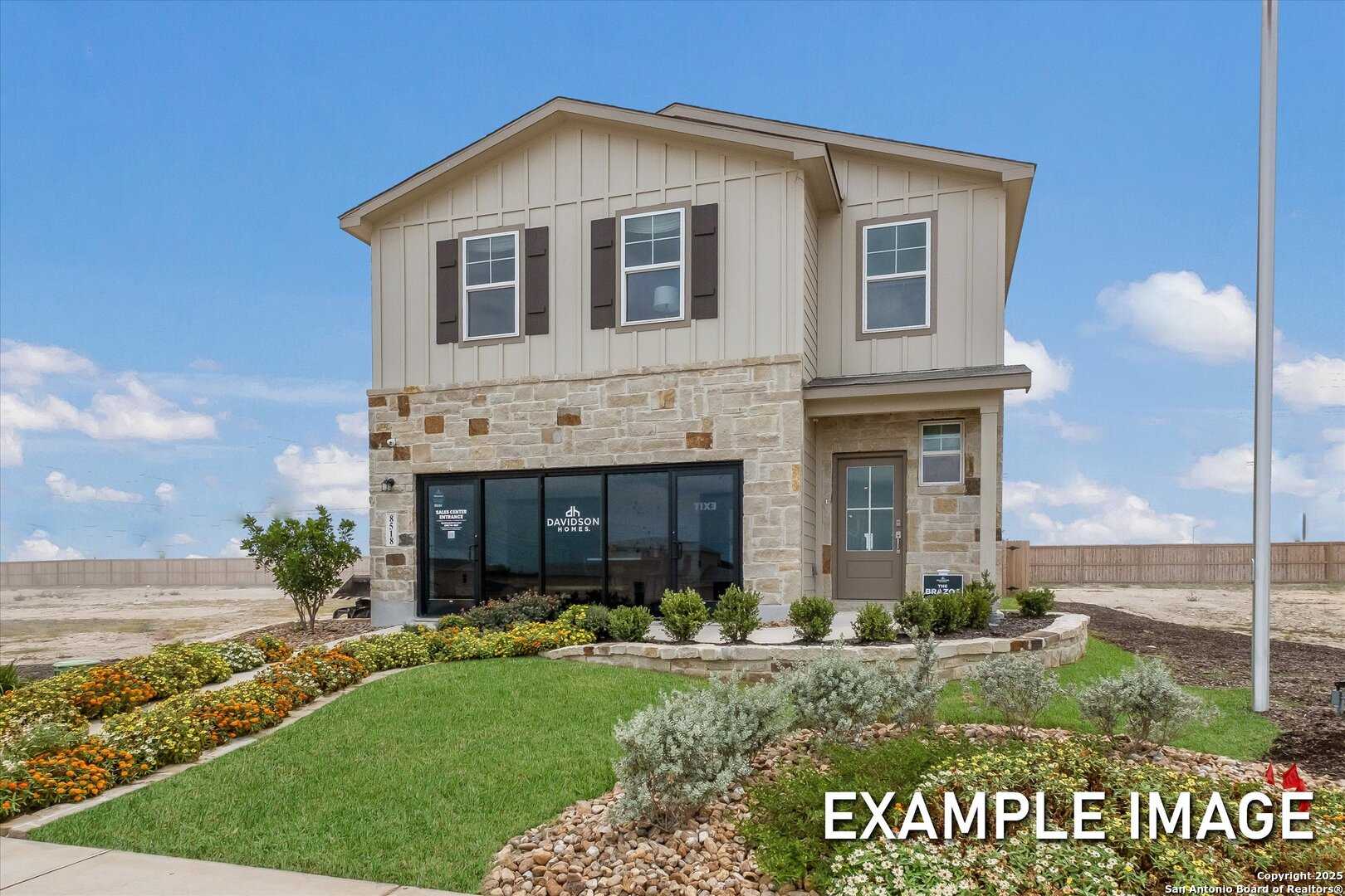 Modern two-story beige home with stone accents, large windows, and landscaped yard in Agave, San Antonio, Texas - Davidson Homes The Brazos C