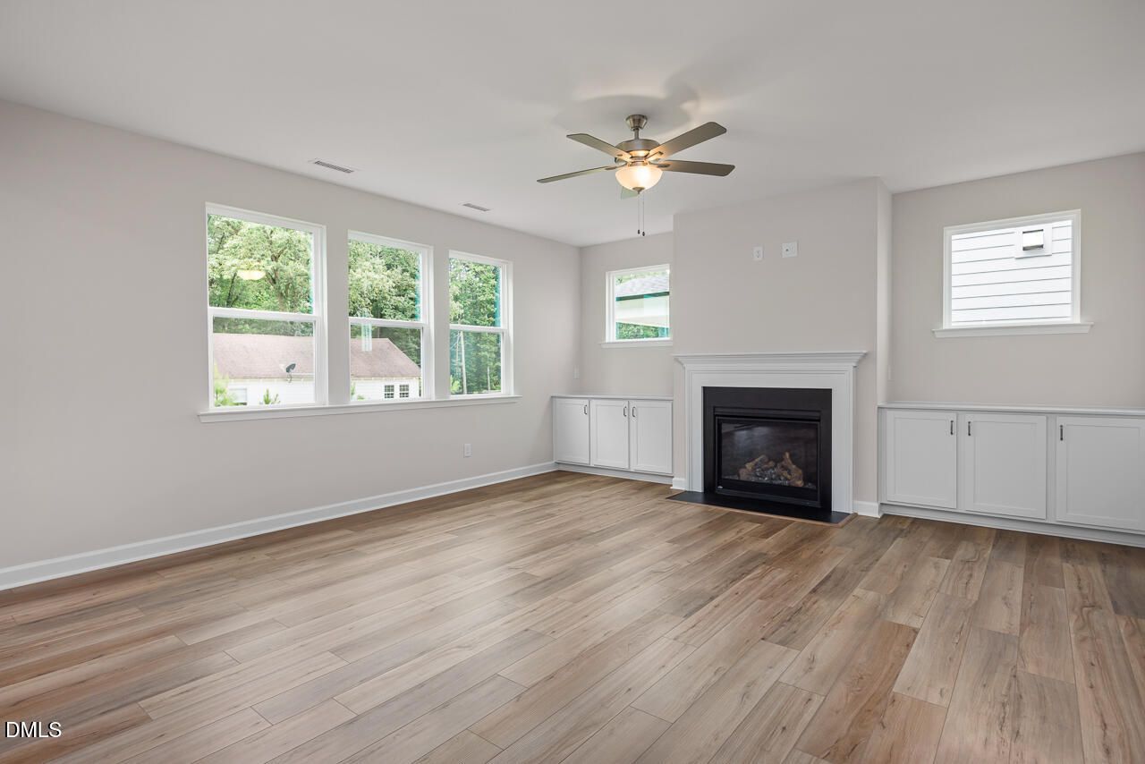 Spacious living room with fireplace and custom built-ins in The Hickory II C floor plan at Montrose, Aberdeen, NC.
