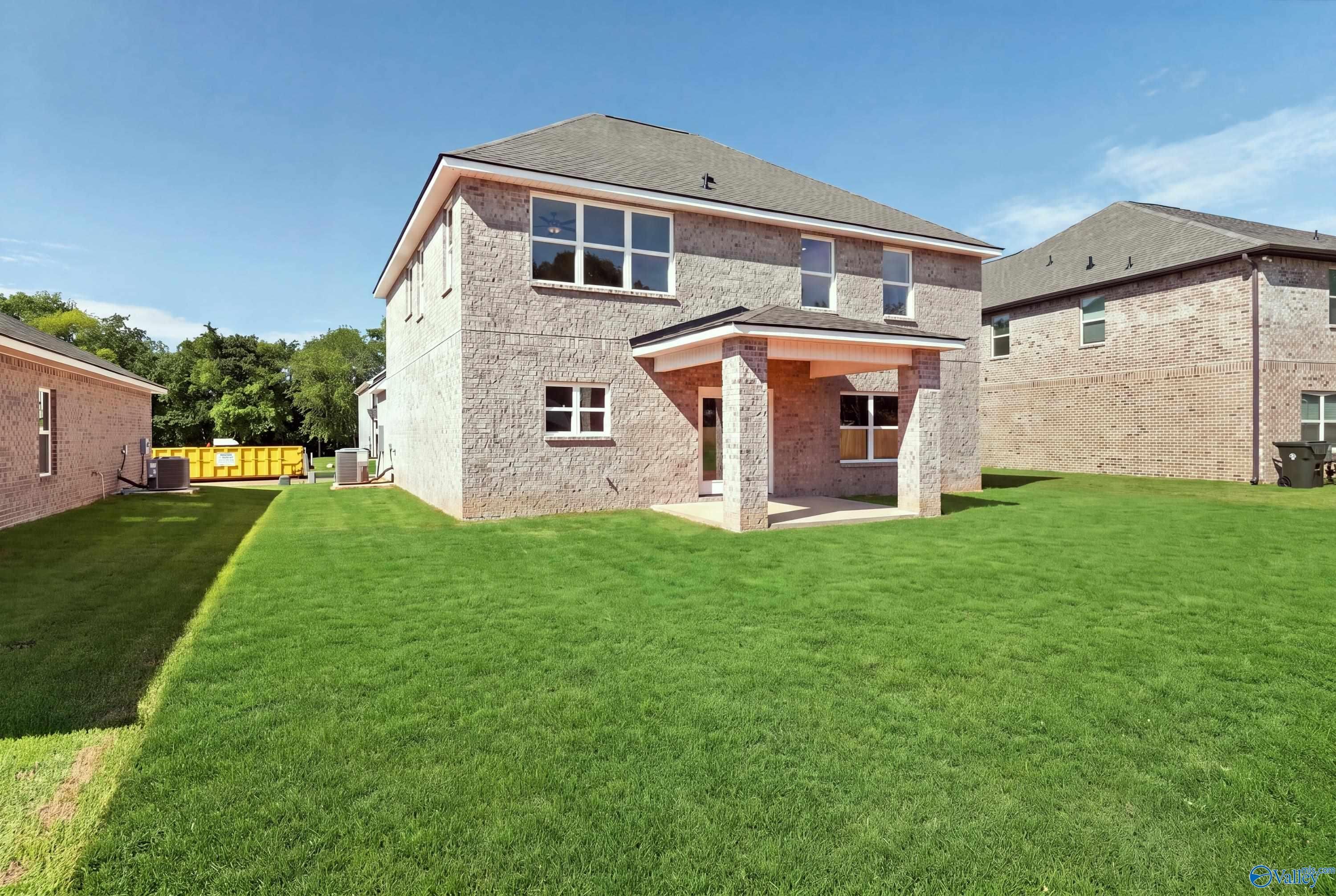 Brick two-story home with covered patio and spacious fenced backyard in Creek Grove, New Market, Alabama by Davidson Homes