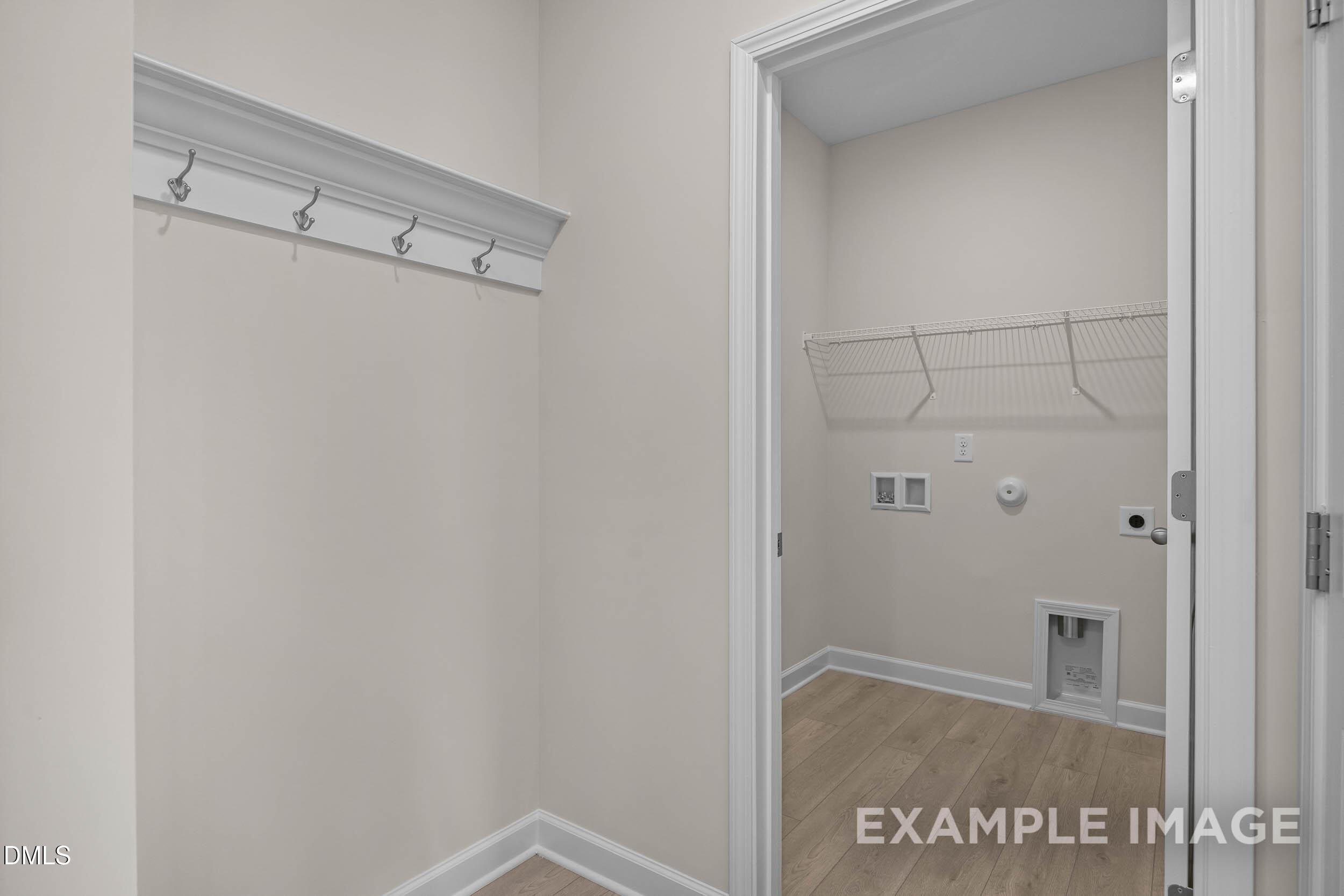Laundry room with shelving and coat rack area in The Franklin C floor plan at Retreat at North Main, Lillington, NC.