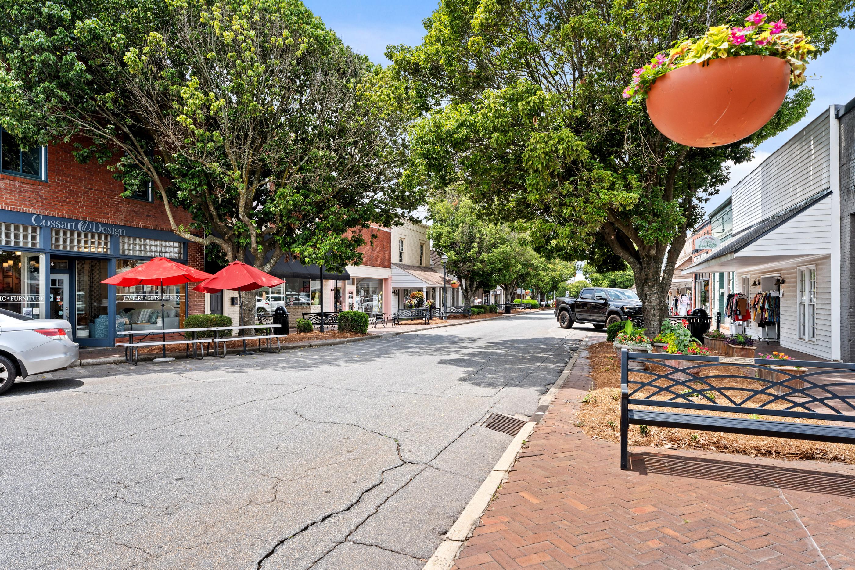 Historic downtown Perry, Georgia near Ivy Glen with charming storefronts, brick sidewalks, and lush trees.