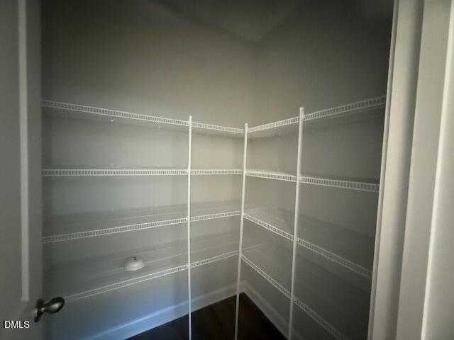 Spacious walk-in closet with adjustable white wire shelving in The Gavin B by Davidson Homes, Gregory Village, Lillington, NC