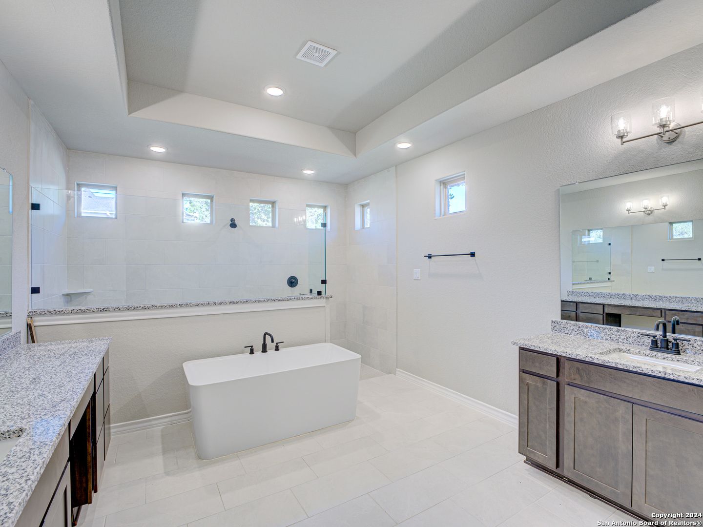 Elegant master bathroom with freestanding tub, double vanity, and walk-in shower in The Summerlin A, Castroville, Texas