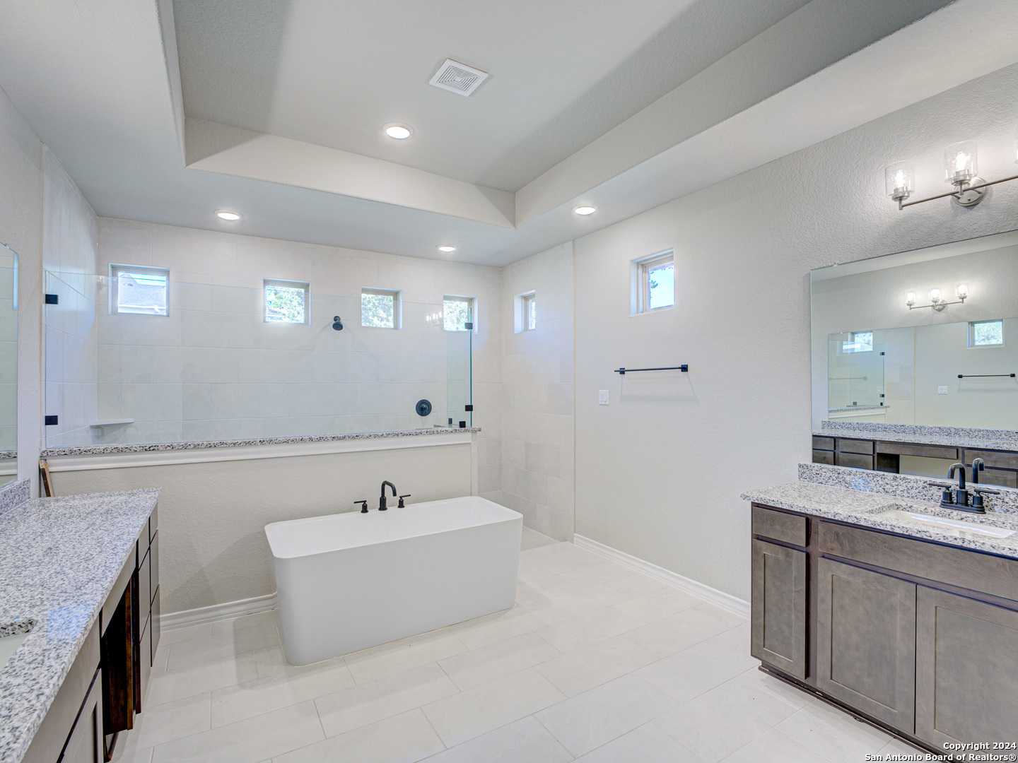 Elegant master bathroom with freestanding tub, double vanity, and walk-in shower in The Summerlin A, Castroville, Texas