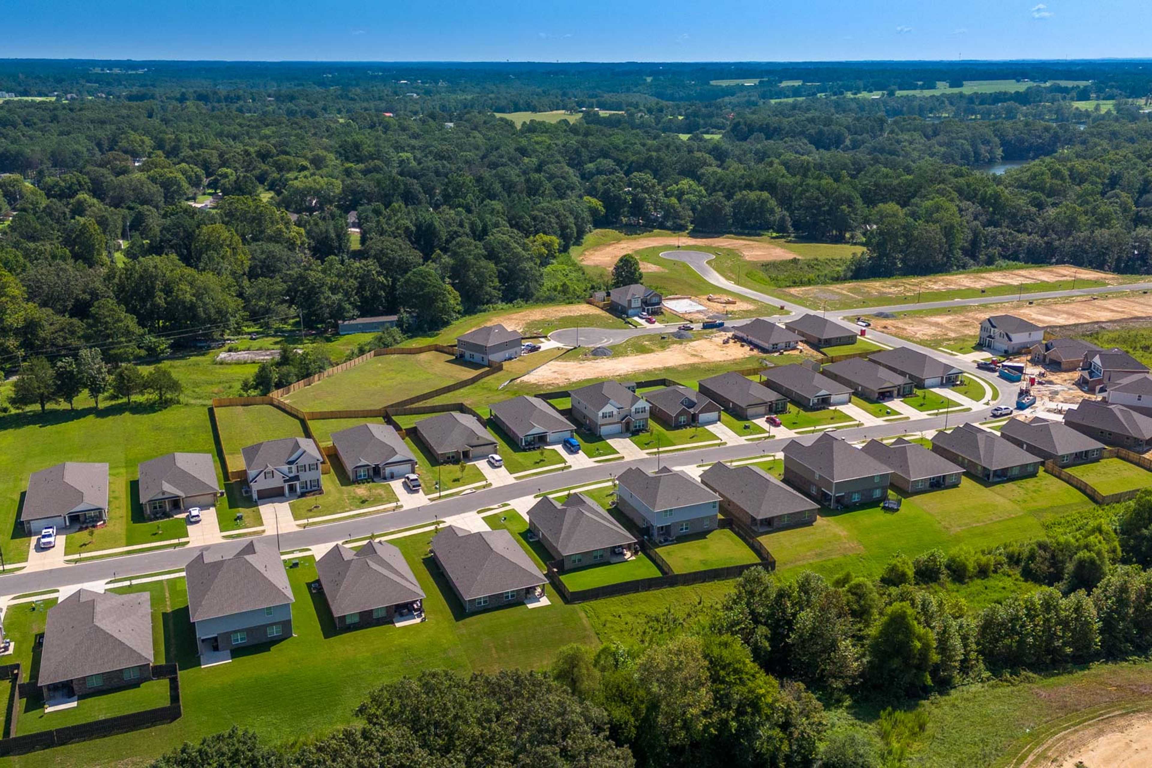 Aerial view of new homes at The Reserve at North Ridge in Cullman Alabama with green lawns and wooded surroundings