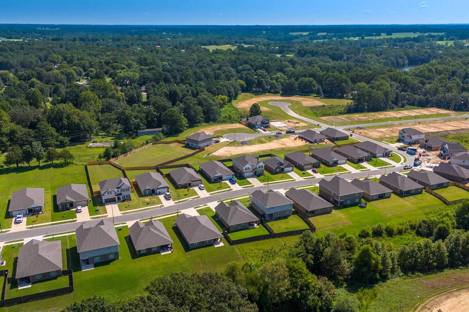 Aerial view of new homes at The Reserve at North Ridge in Cullman Alabama with green lawns and wooded surroundings