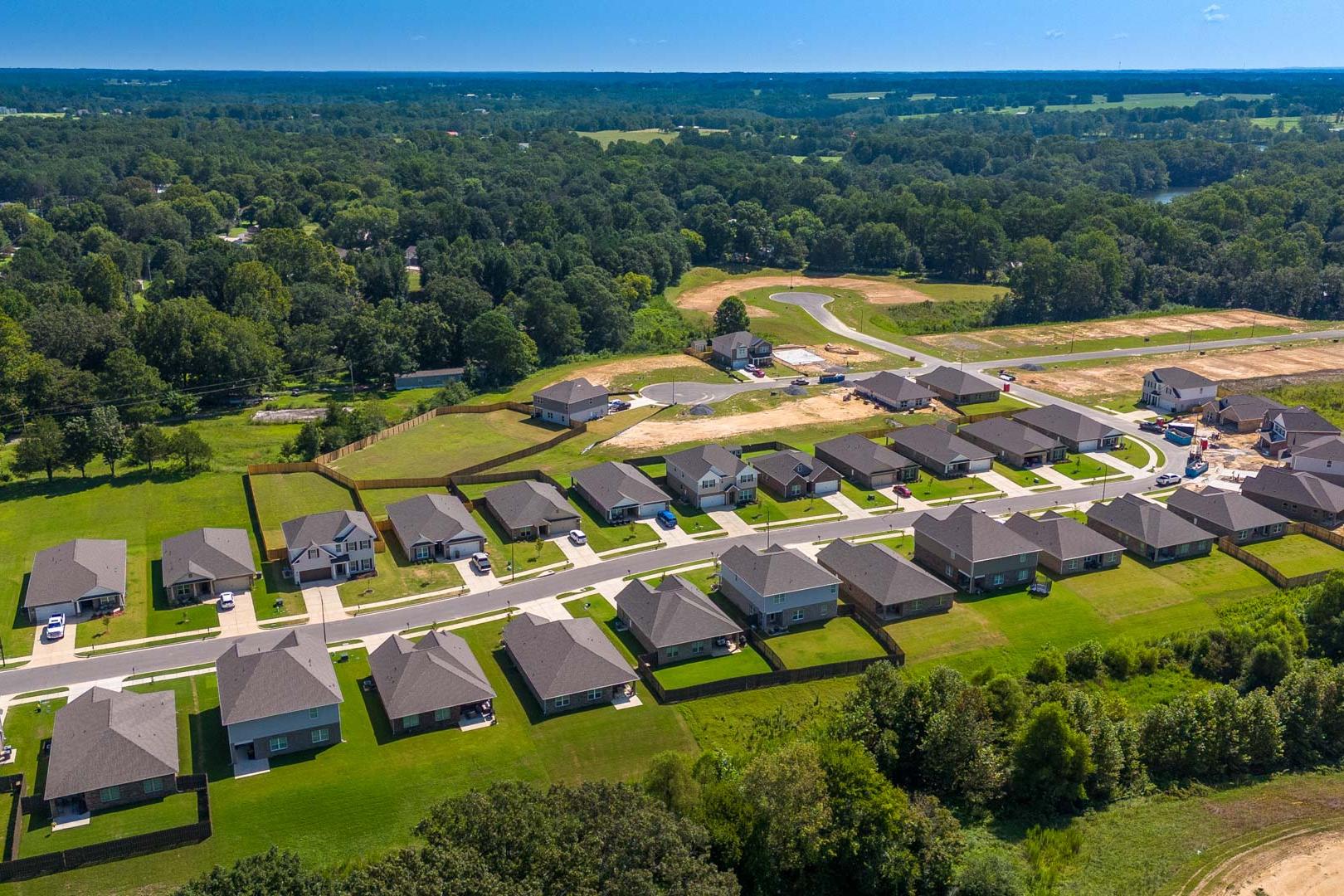 Aerial view of new homes at The Reserve at North Ridge in Cullman Alabama with green lawns and wooded surroundings
