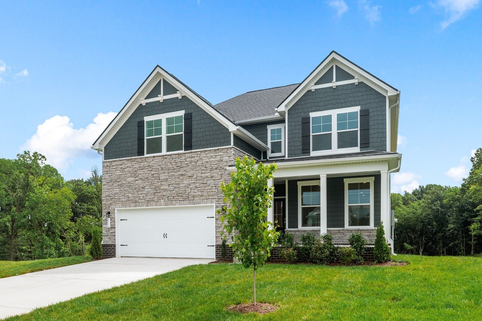 Two-story Willow floor plan home by Davidson Homes with stone and siding exterior in Calista Farms, White House, Tennessee.