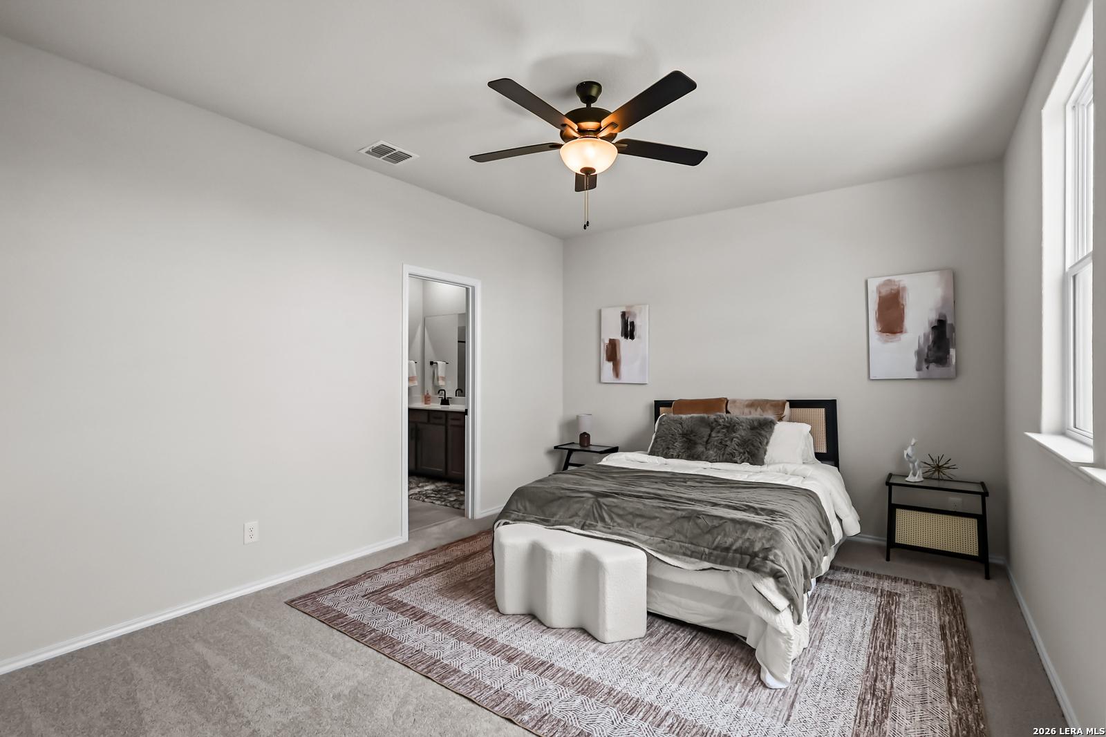Spacious bedroom with en-suite bath in The Douglas C floor plan by Davidson Homes at Hannah Heights in Seguin, Texas.