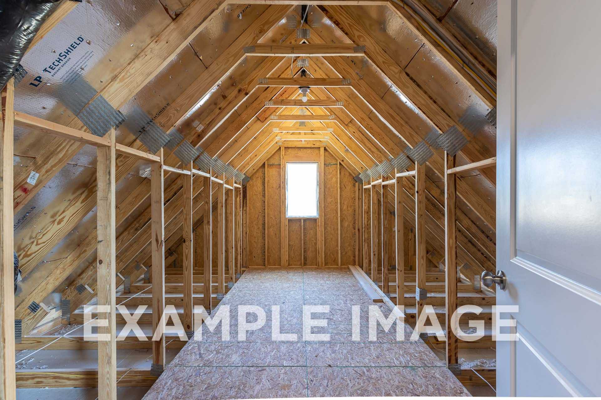 Exposed wooden trusses and insulated framing in The Ash E upper hallway, two-story home design by Davidson Homes in Angier, NC