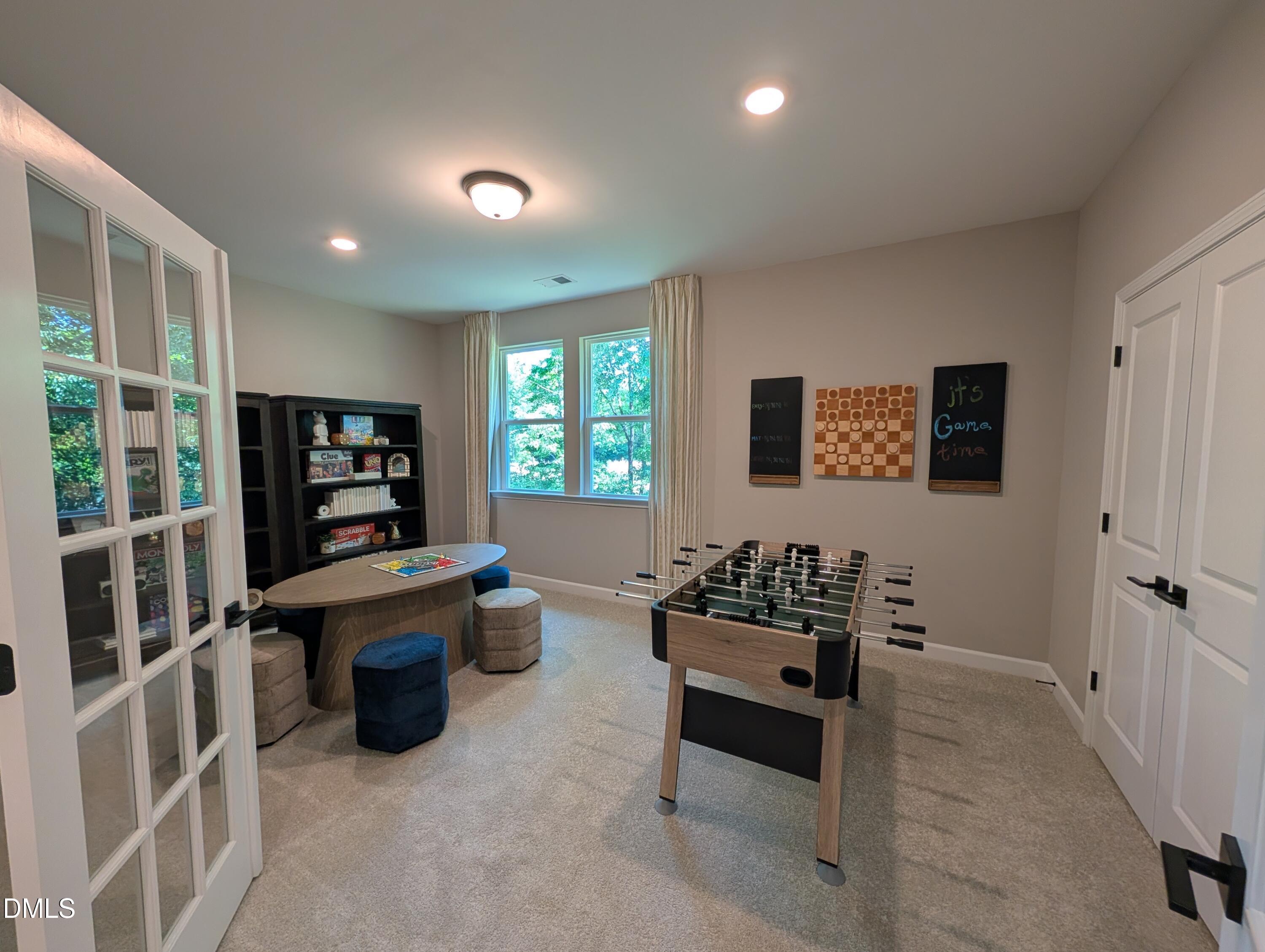 Game room with foosball table and gaming nook in The Aspen B floor plan at Wendell Ridge, Wendell, North Carolina.