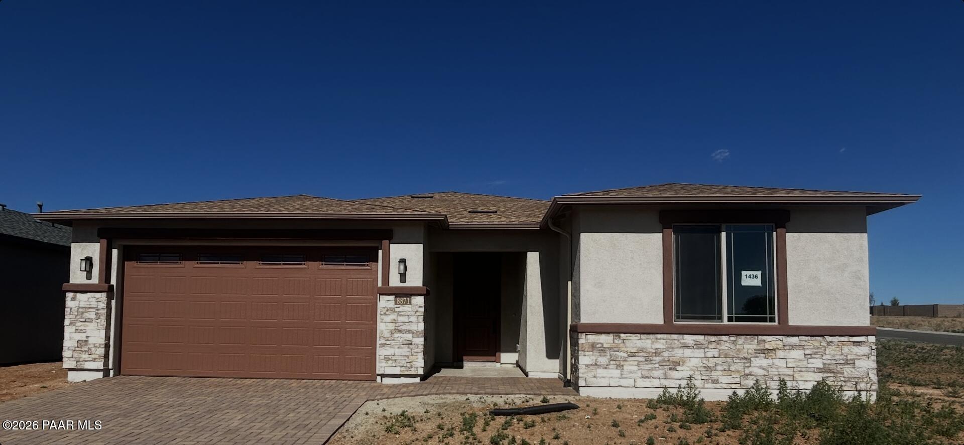 Single-story 3-car garage home with stucco and stone exterior in North Ridge at Pronghorn Ranch, Prescott Valley, Arizona