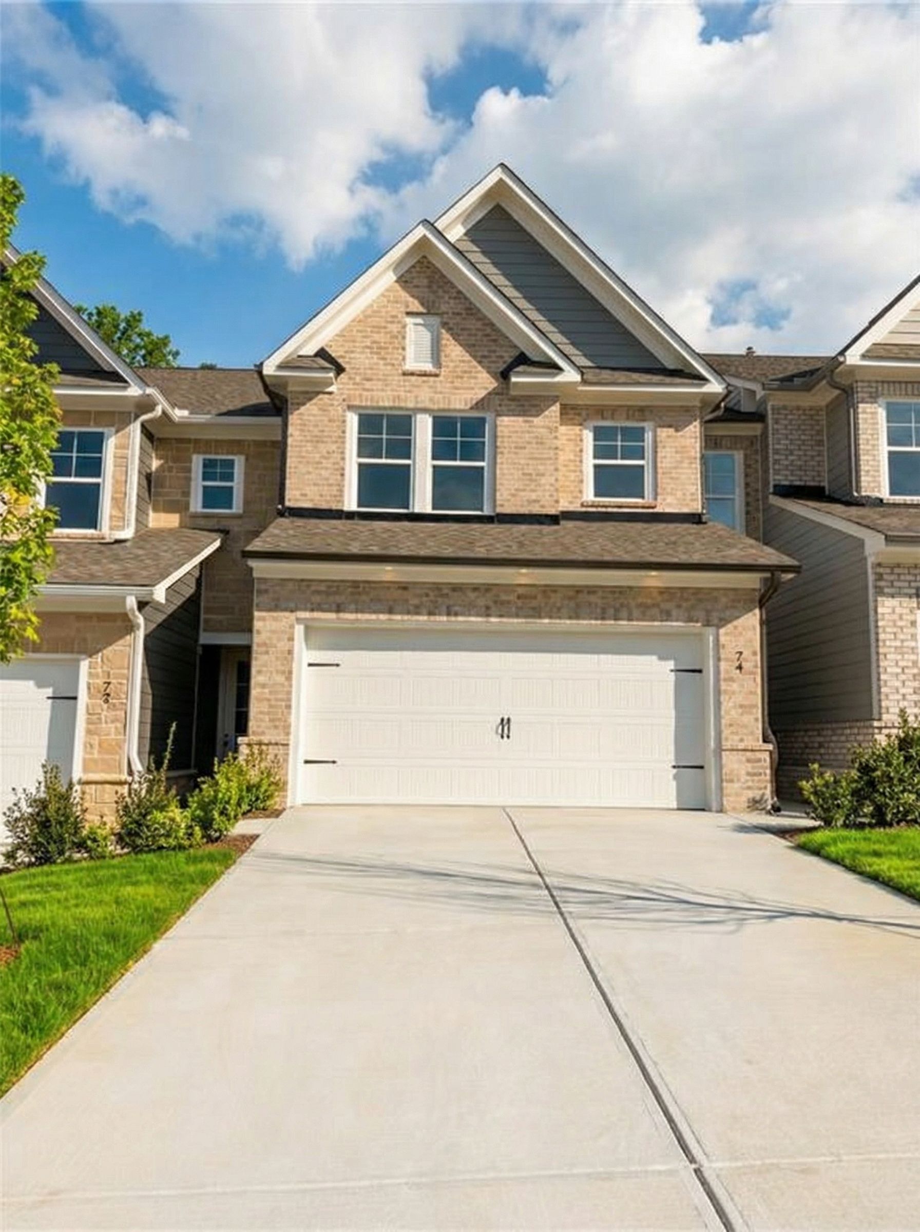 Two-story brick home with 2-car garage, driveway, and green landscaping in Lake Shore, Winder, Georgia - Davidson Homes The Cary A