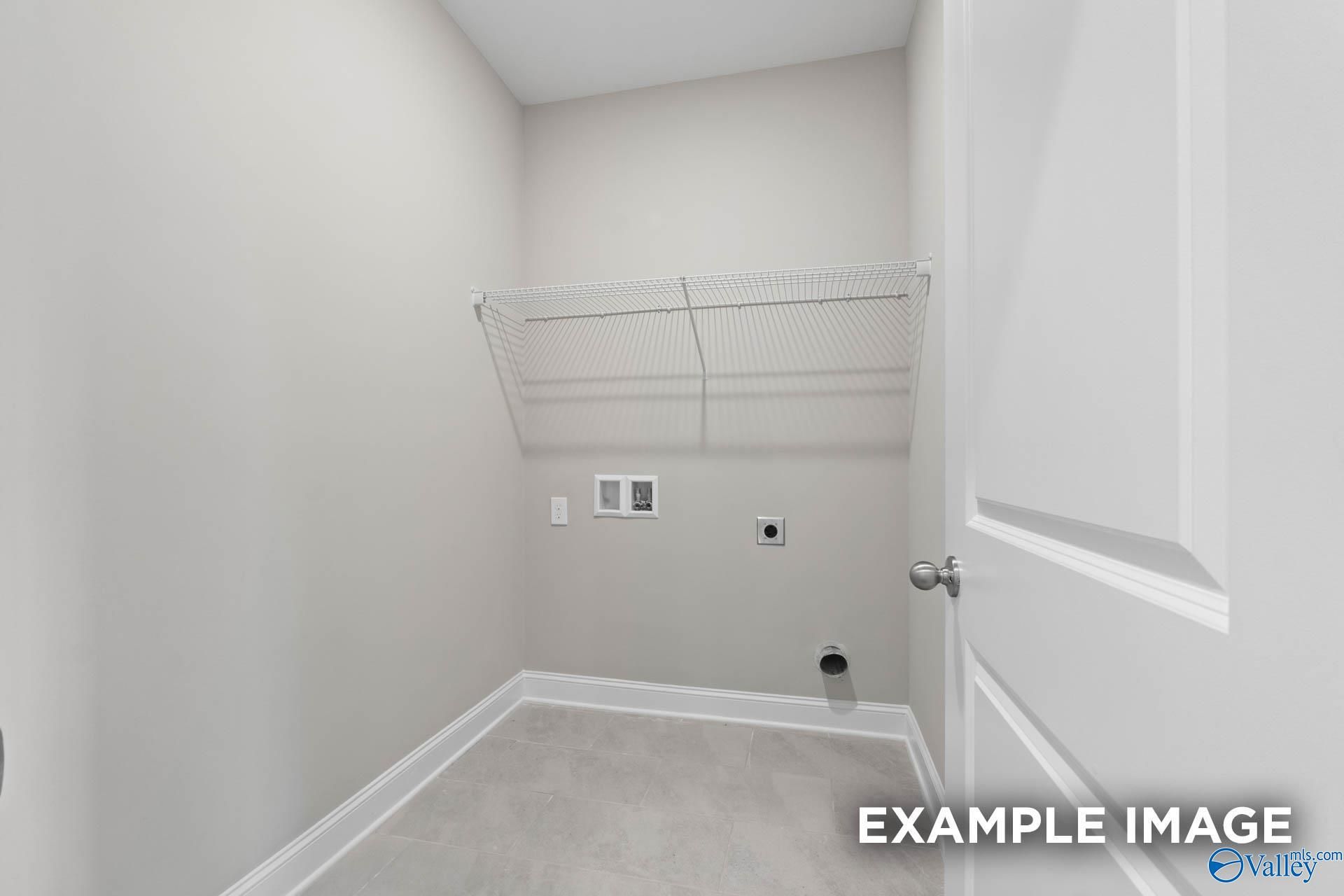 Modern laundry room with wire shelving, washer/dryer hookups in Davidson Homes The Montgomery B, Hartselle, Alabama